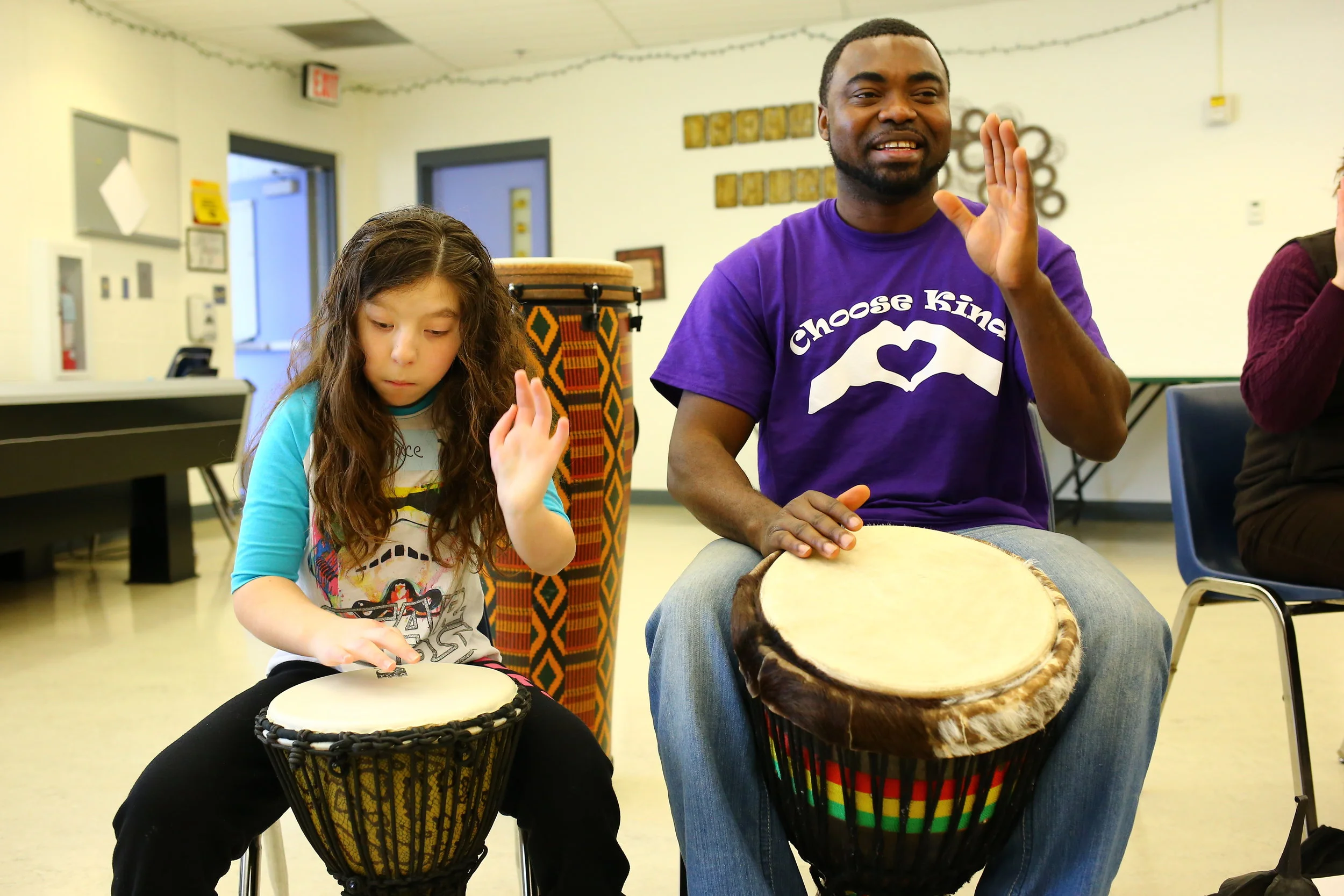 Growing together: Christian Adeti and a student at the Minnesota Academy of the Blind practice their drumming technique