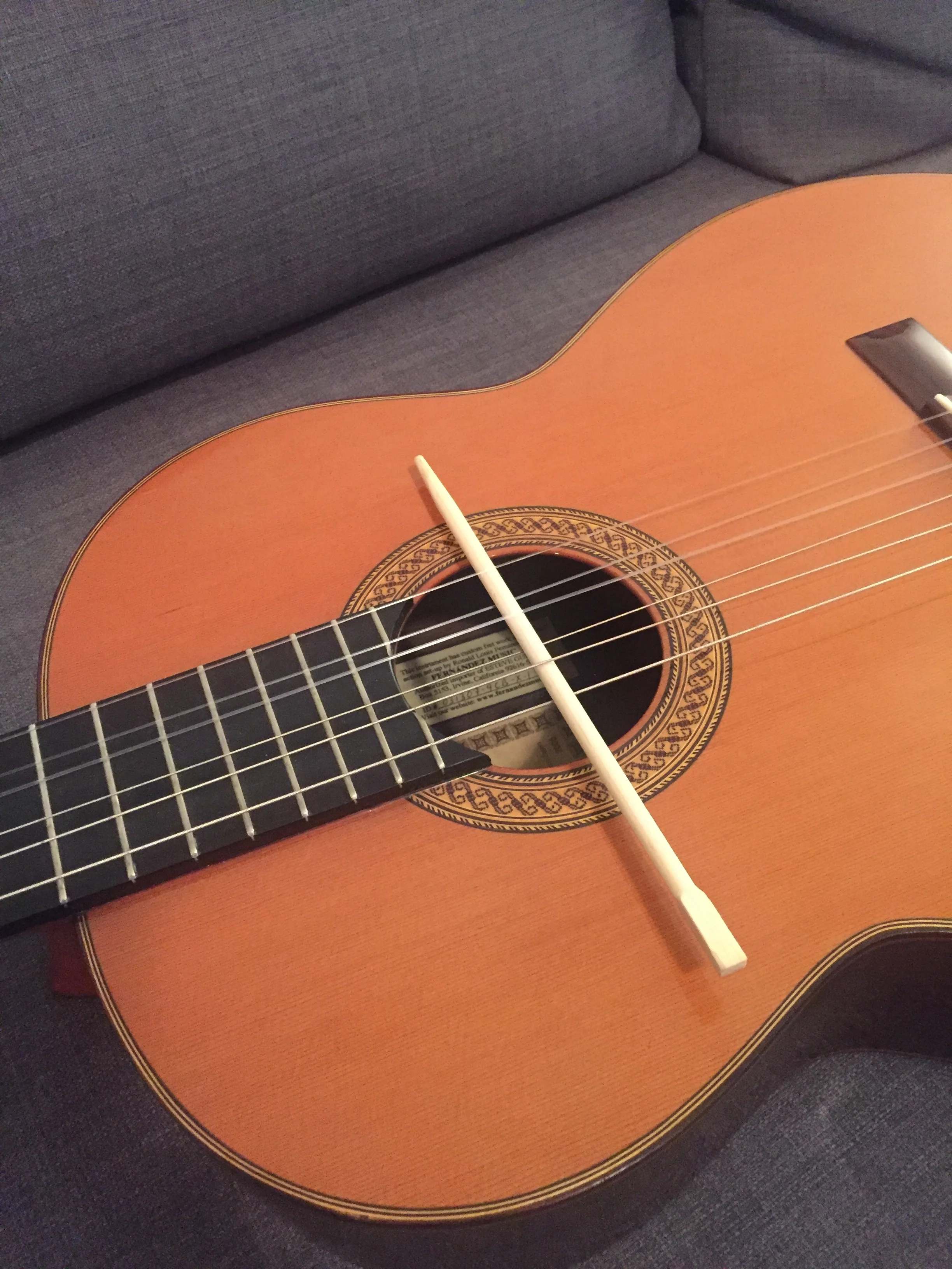 Step 3 - thread a chopstick (over/under) through all six strings of the guitar at the theoretical 24th fret. Start over the low E string as illustrated. 