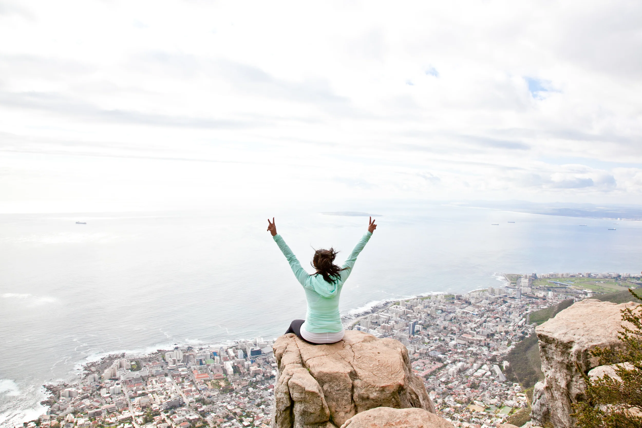 Sitting on the edge of Lion's Head in Cape Town, South Africa