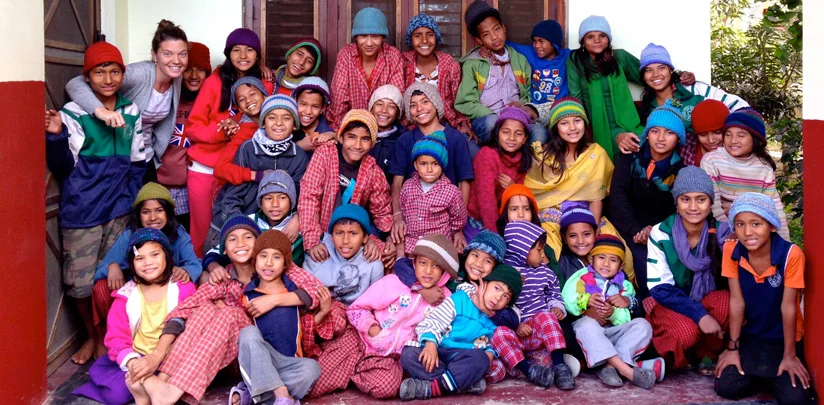 Maggie Doyne in 2014 with over 35 of her adopted children. | photo courtesy of blinknow.org
