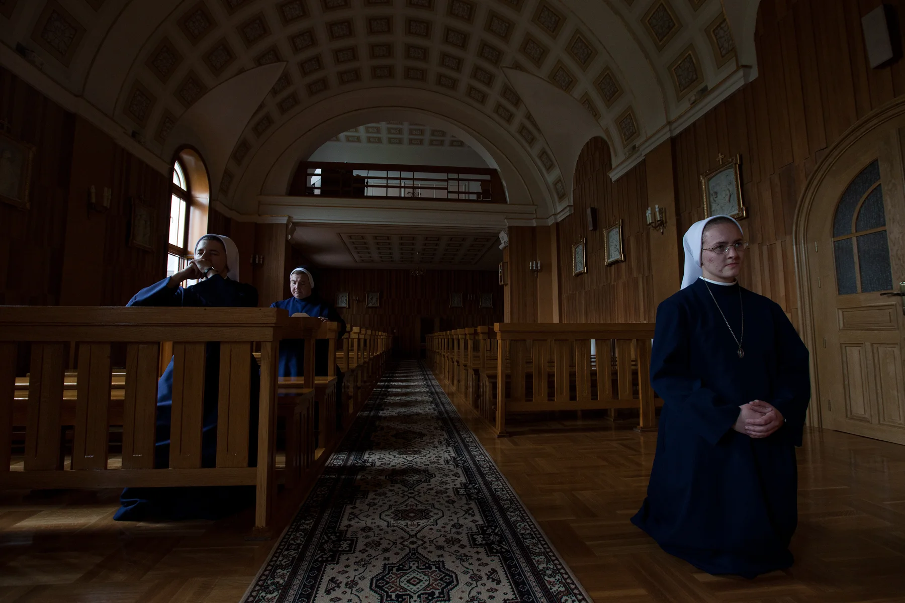Catholic nuns pray in a convent chapel. Taken in southeast Poland. Image ©Connor Stefanison