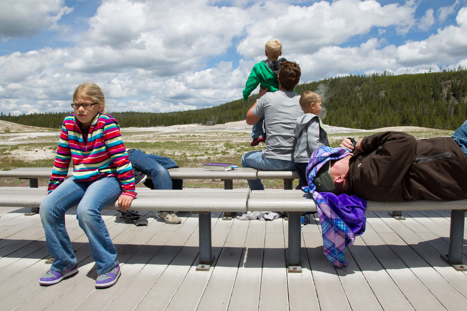 Tourists in Yellowstone National Park wait for the world famous Old Faithful geyser to erupt. Image ©Connor Stefanison