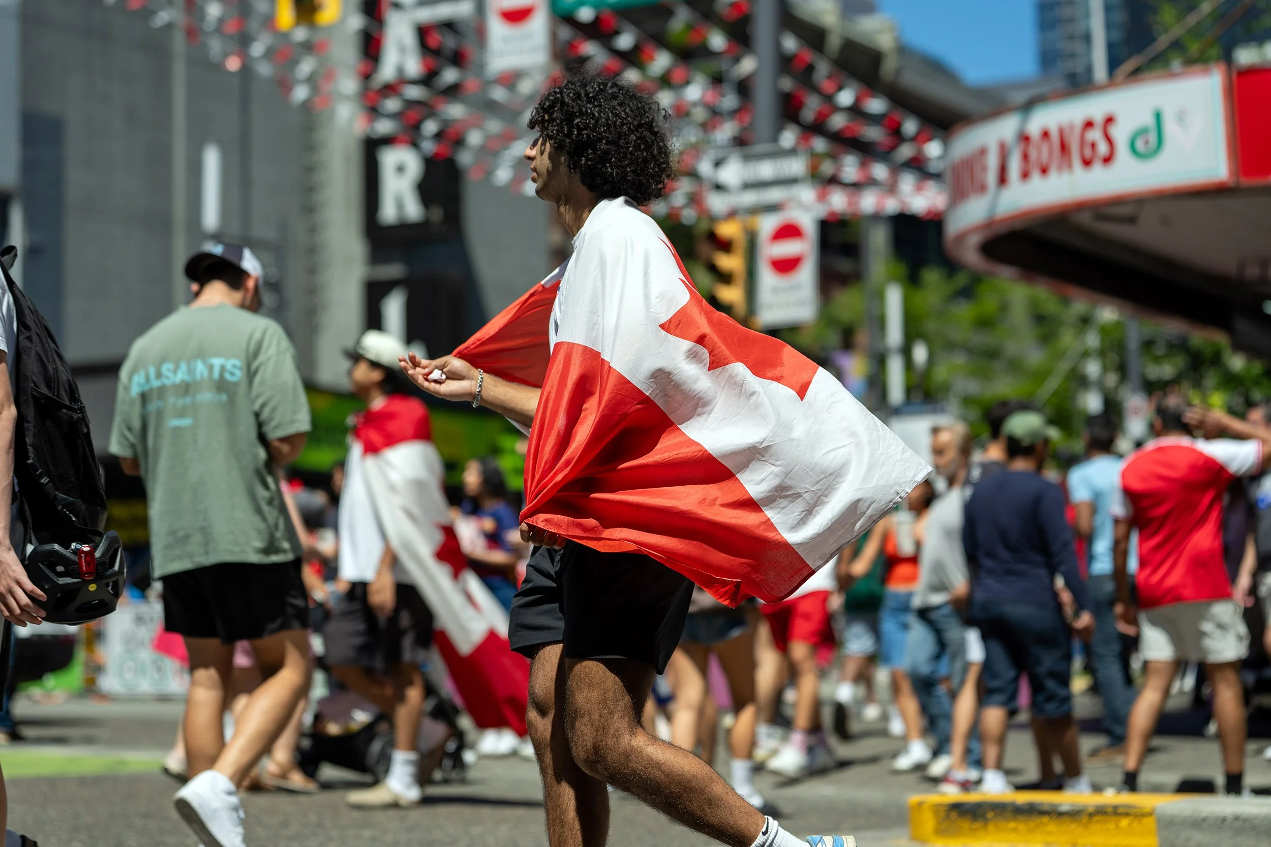 Canadian soccer fan on Granville Street, Vancouver, during the 2026 World Cup. Sample image from a Sony FE 50-150mm f/2 GM and Sony A7 V.