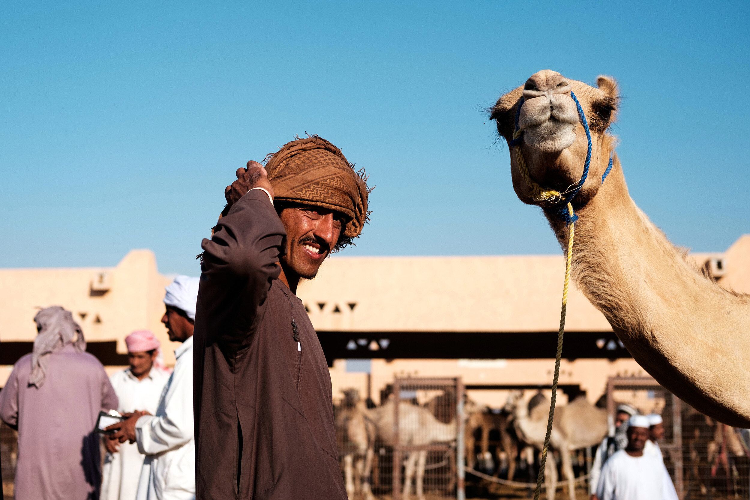 A man poses with his camel at the camel souk in Al Ain, Untied Arab Emirates. Sample image from a Fujifilm XF 35mm f/2 R WR