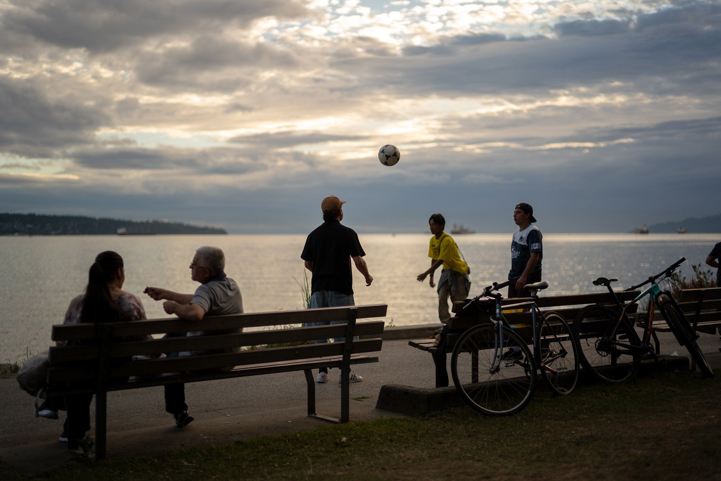 Young men playing soccer by English Beach in Vancouver, July 9, 2026