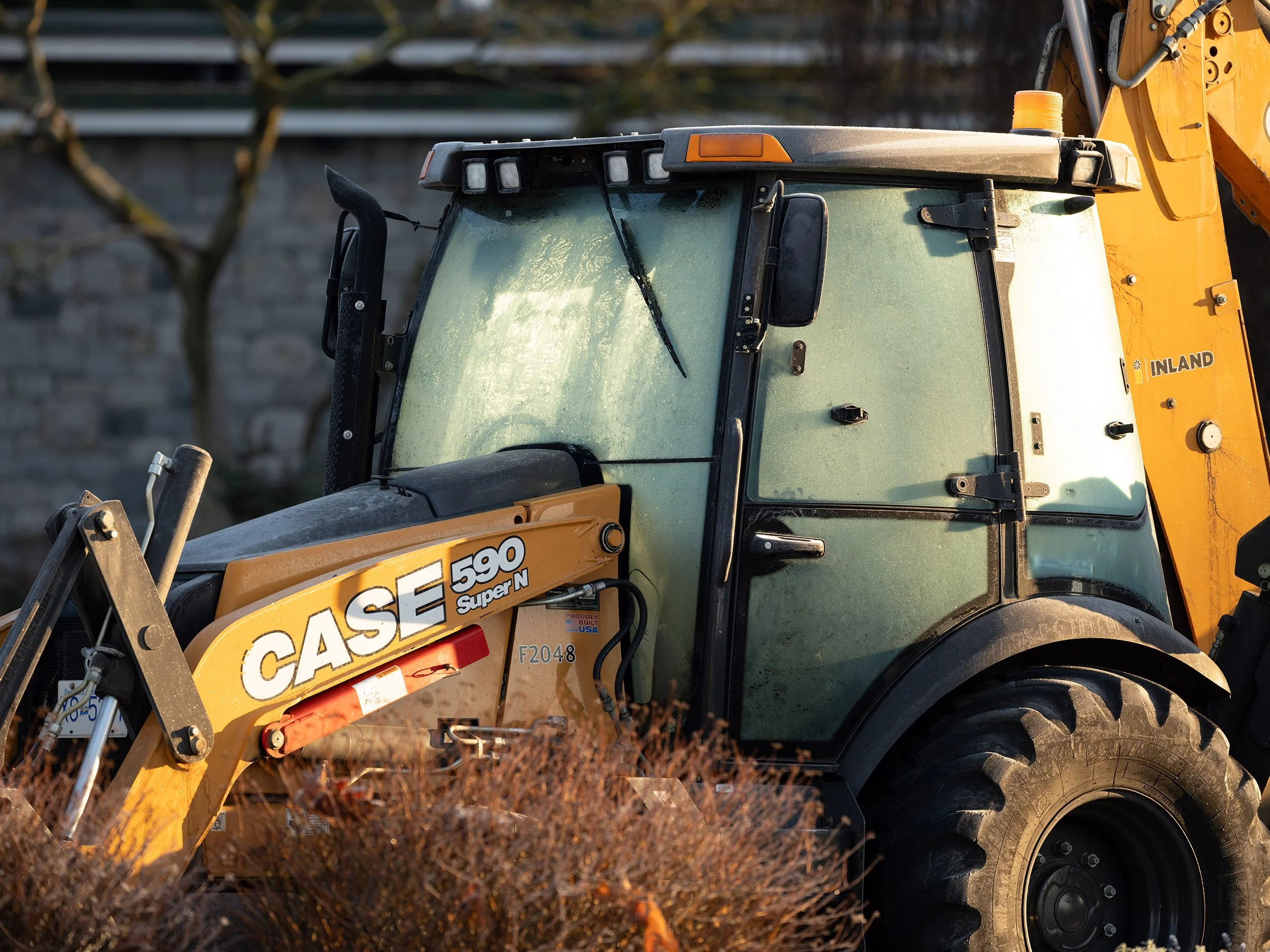A tractor park along Beach Drive in Vancouver. Sample image from a Fujifilm GFX 100S II and Fujifilm GF 500mm f/5.6 R LM OIS WR.