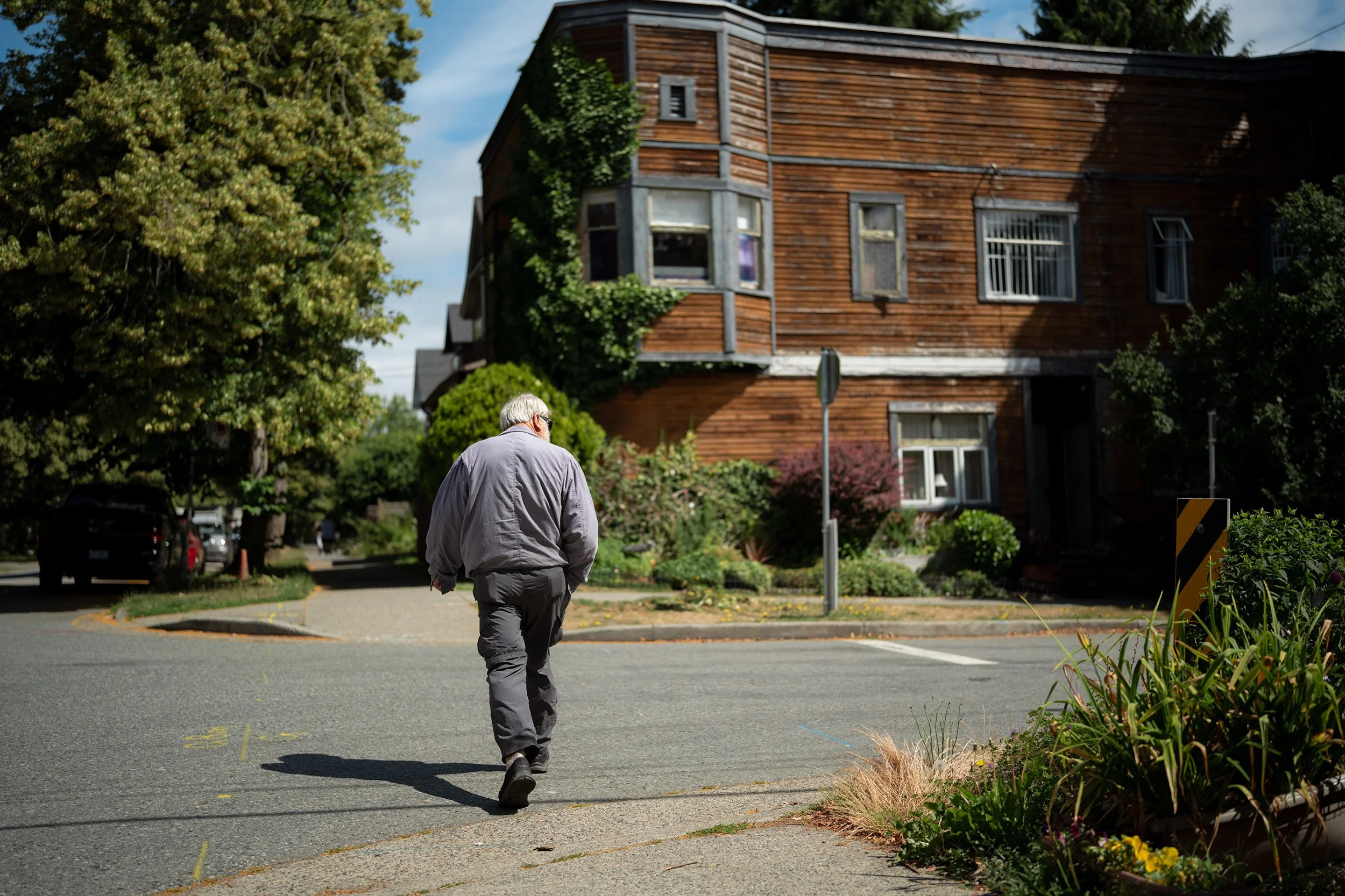 A man crosses the street at Arbutus. Sigma 35mm f/1.4 DG II Art (Sony E-Mount) on a Sony A7V.