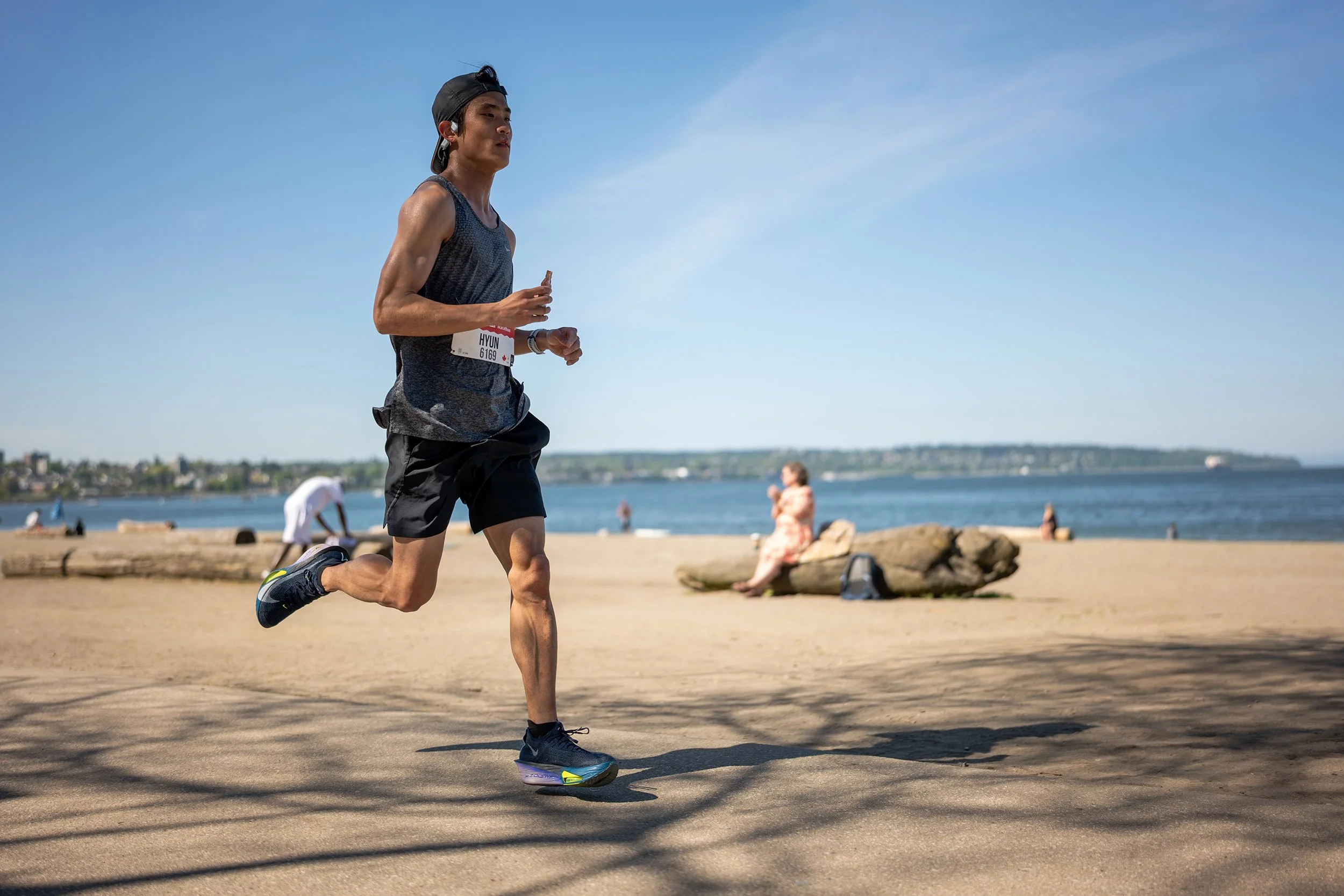 2026 Vancouver Marathon runner at English Bay. Sample image from a Sigma 35mm f/1.4 DG II Art and Leica SL2-S.