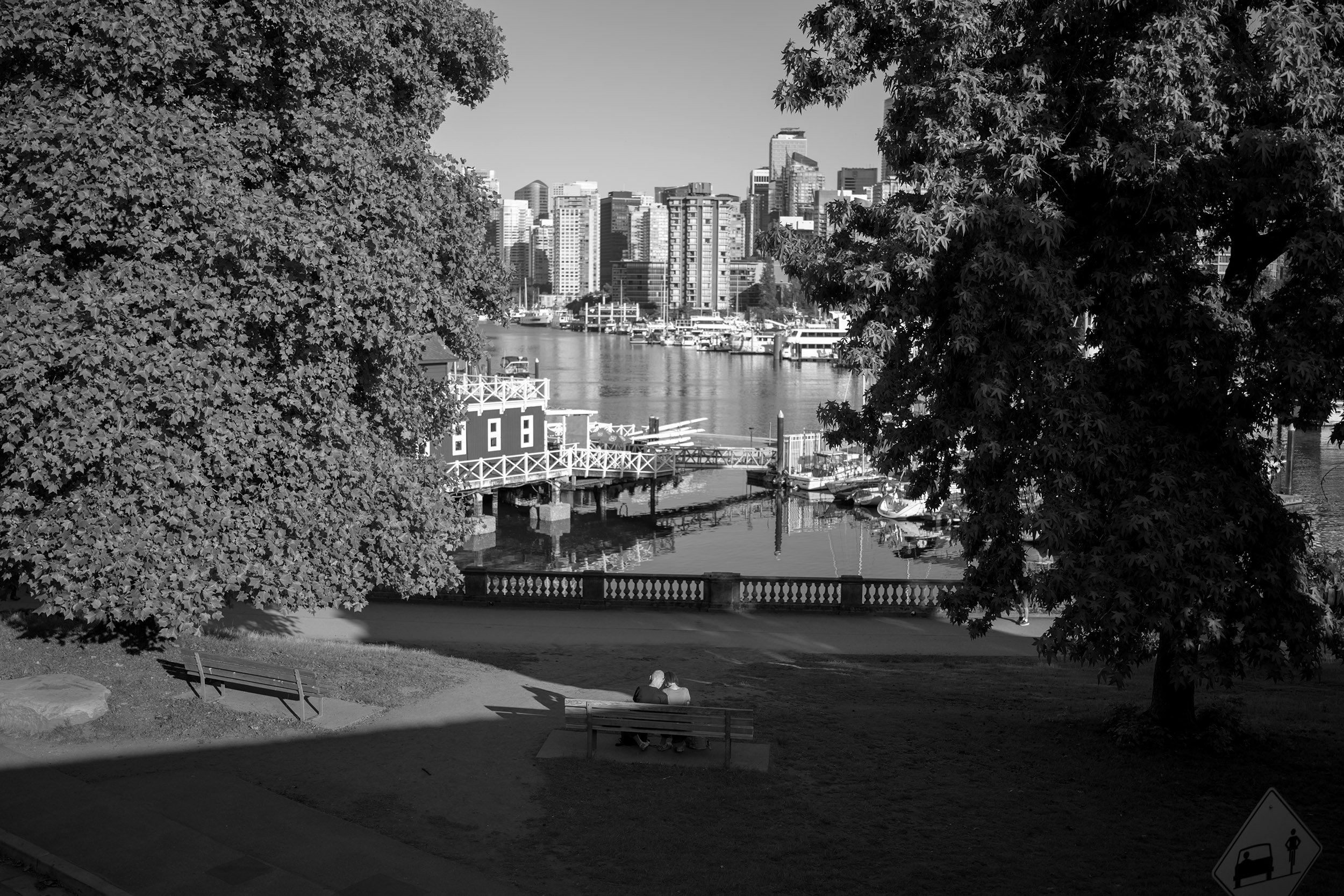 A couple on a bench by Coal Harbour in Vancouver, July 4th 2026