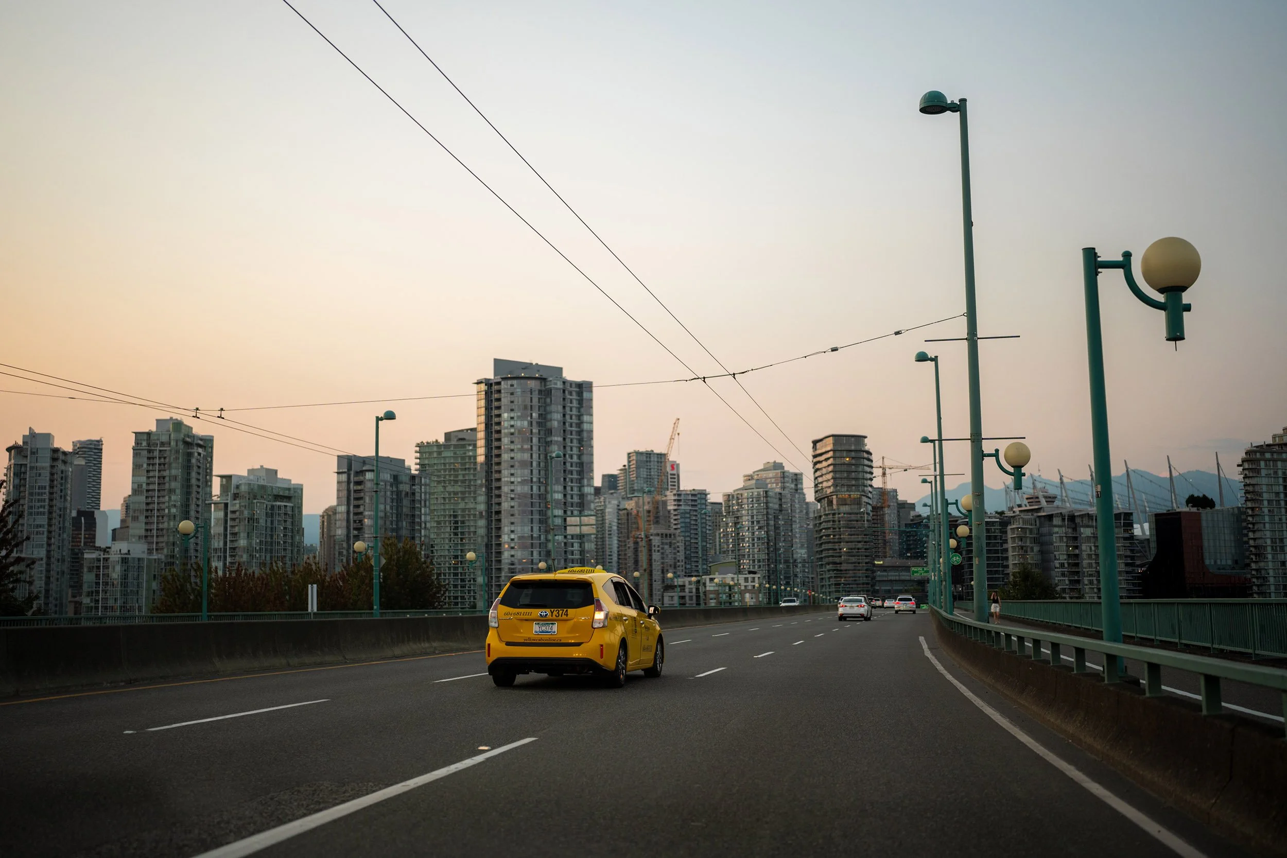 A cab crosses the Cambie Bridge on an August evening, 2026.