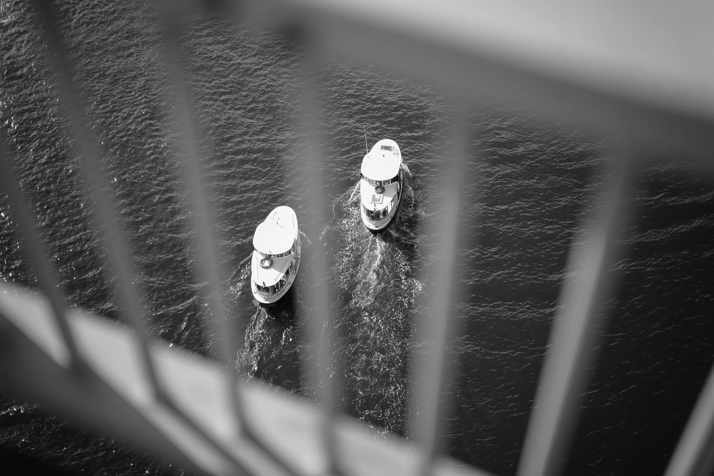 Two False Creek Ferries sail under the Granville Bridge