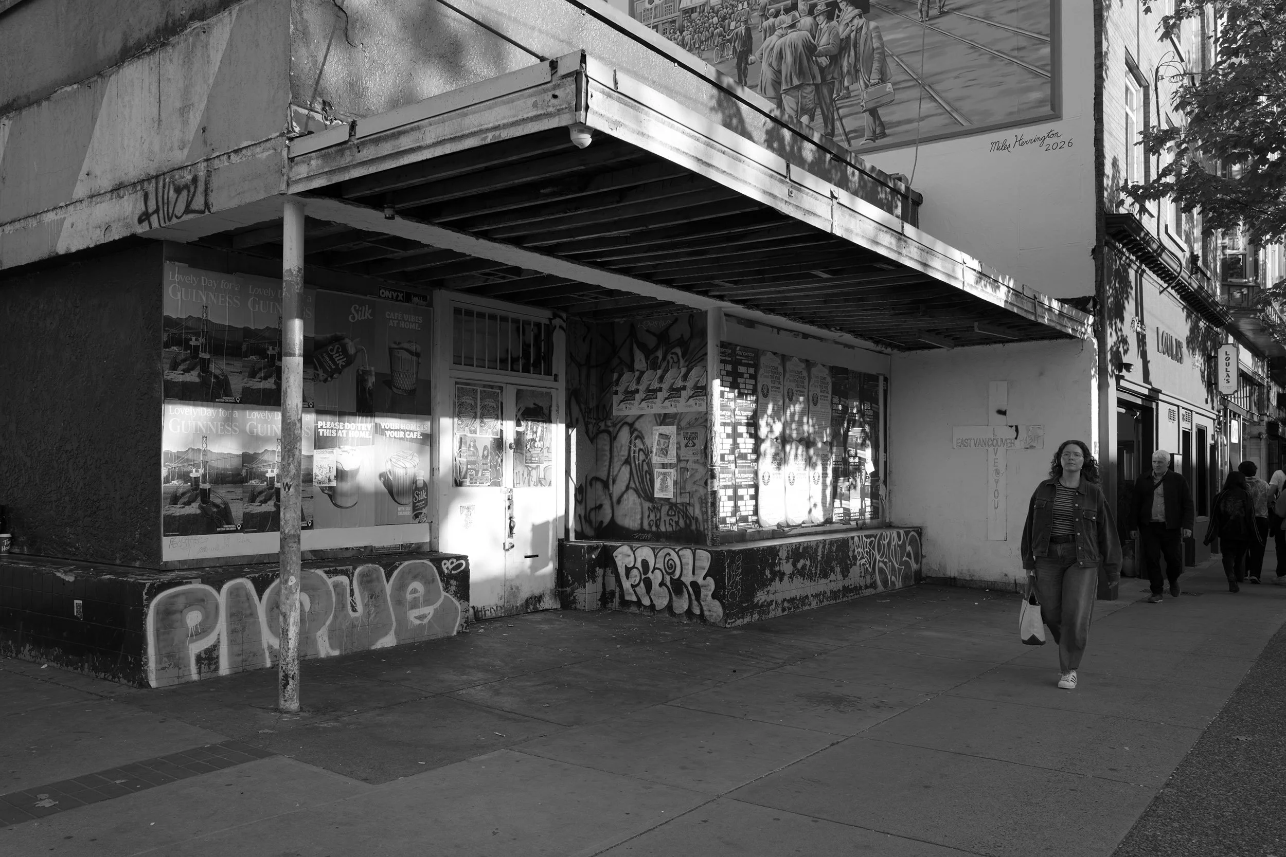 Posters and Grafitti on a close down shop on Commercial Drive in Vancouver. Black-and-white sample photo from a Leica Q Typ 116