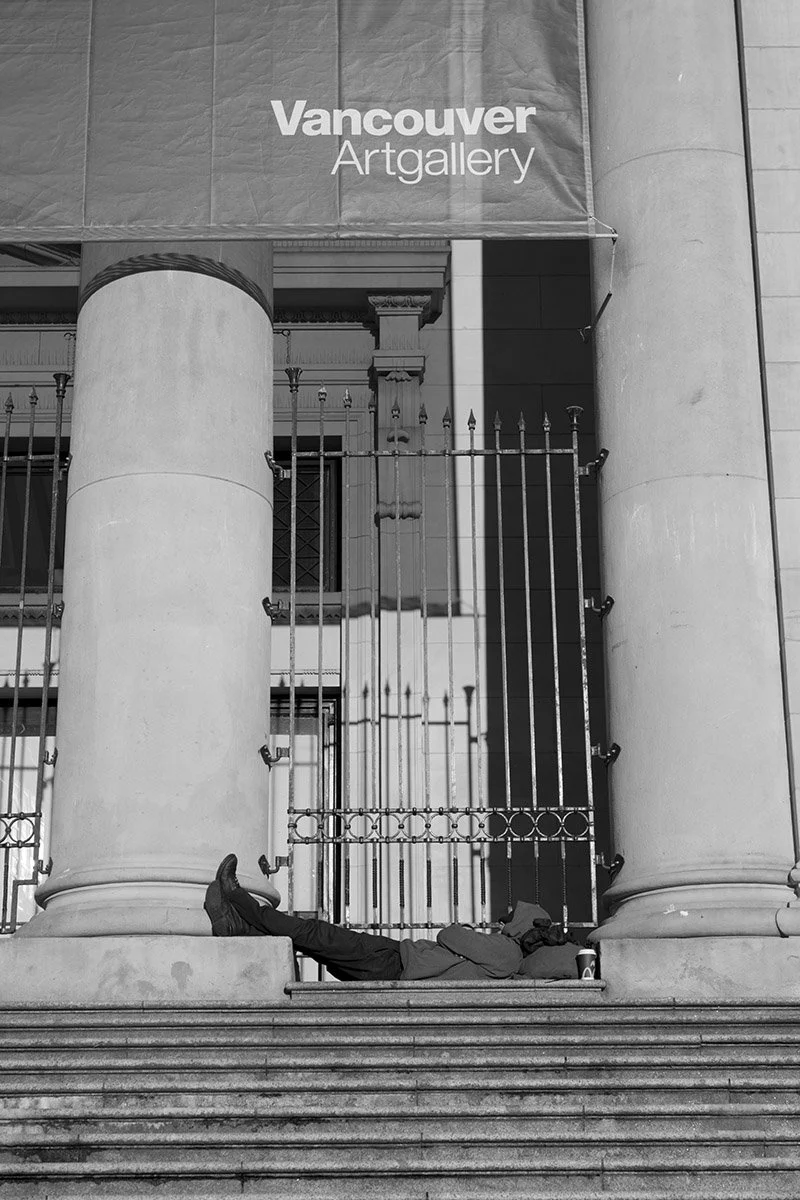 A man is having a rest on the stairs by the Vancouver Art Gallery. Sample image from a Sigma 17-40mm f/1.8 DC Art and Fujifilm X-E5.