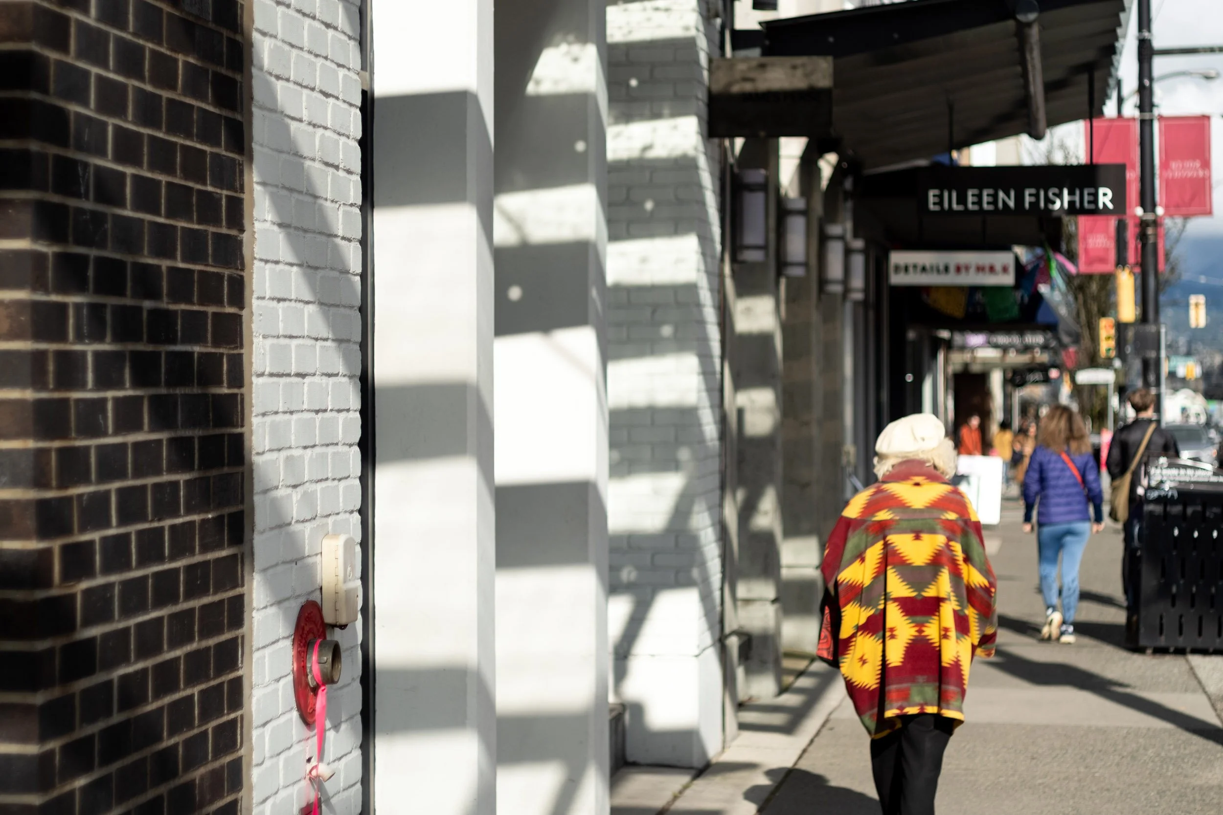 A woman walk down Granville Street in February 2026