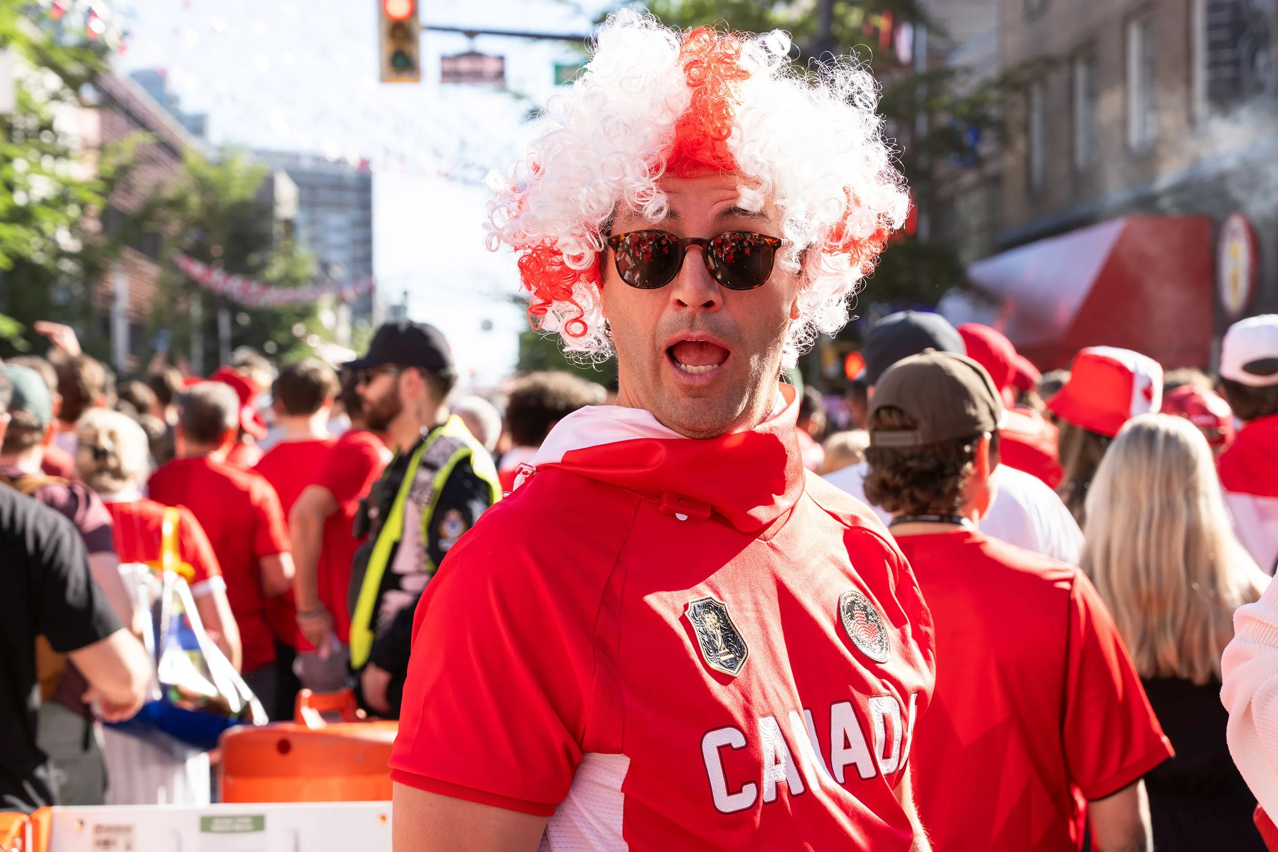 A man celebrates before the Canada - Qatar game on Granville Street in Vancouver