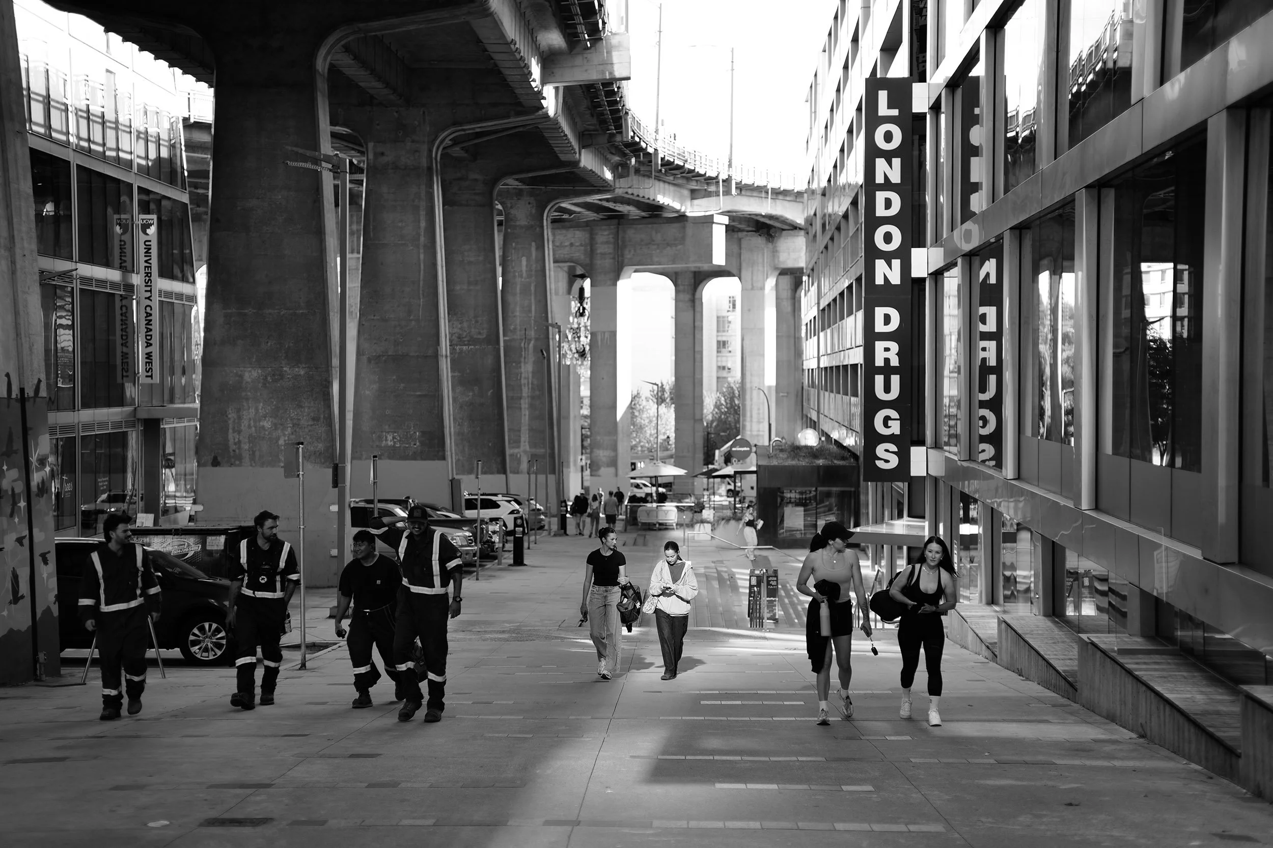Life unfolds beneath the Granville Bridge on a late August day 2026