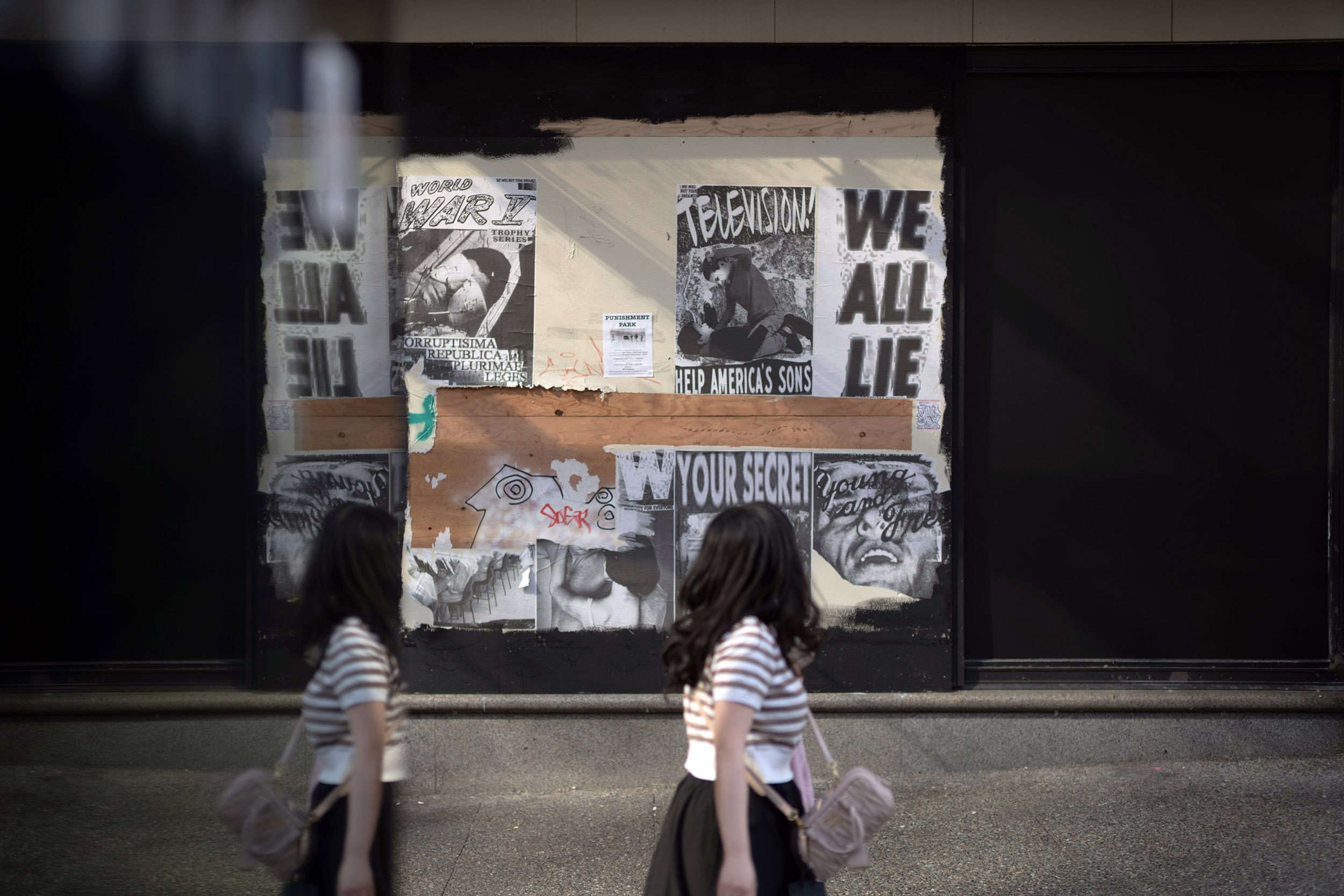 We all lie poster on Granville Street in Vancouver. August 2026