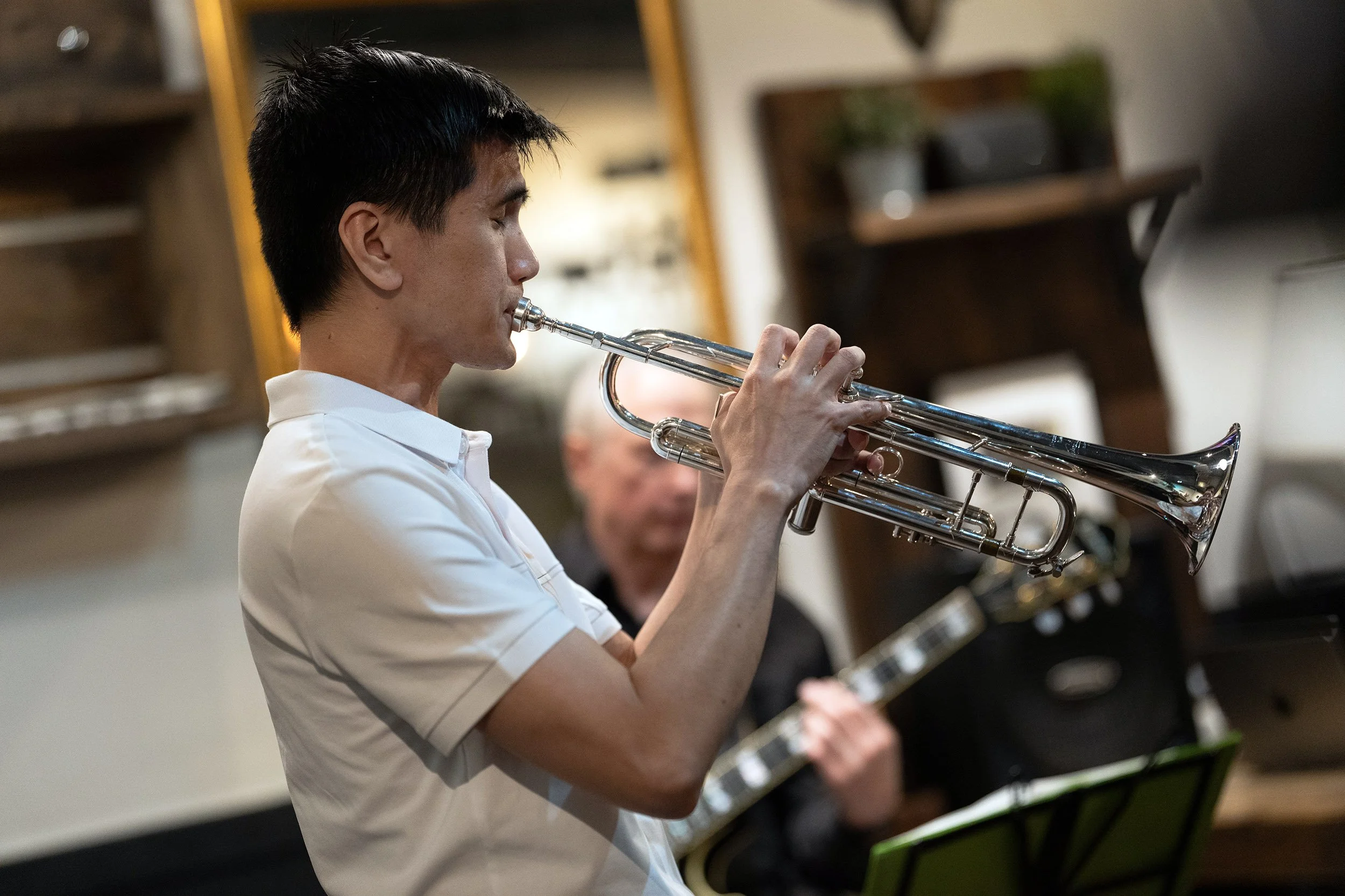 The trumpet player with Jacz at Aperture Coffee in Vancouver. Sample image from a Sony FE 50-150mm f/2 GM and Sony A7 V.