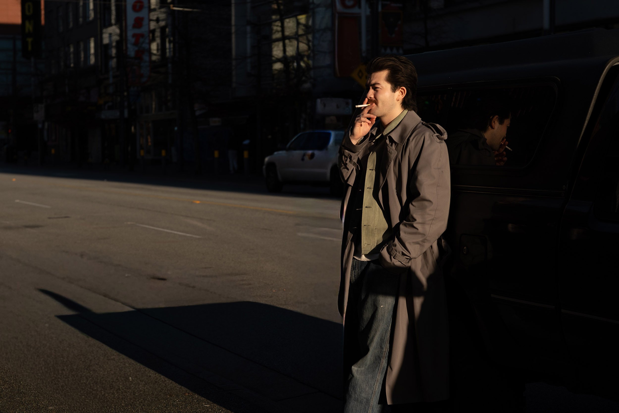 A man is having smoke on Granville Street in Vancouver