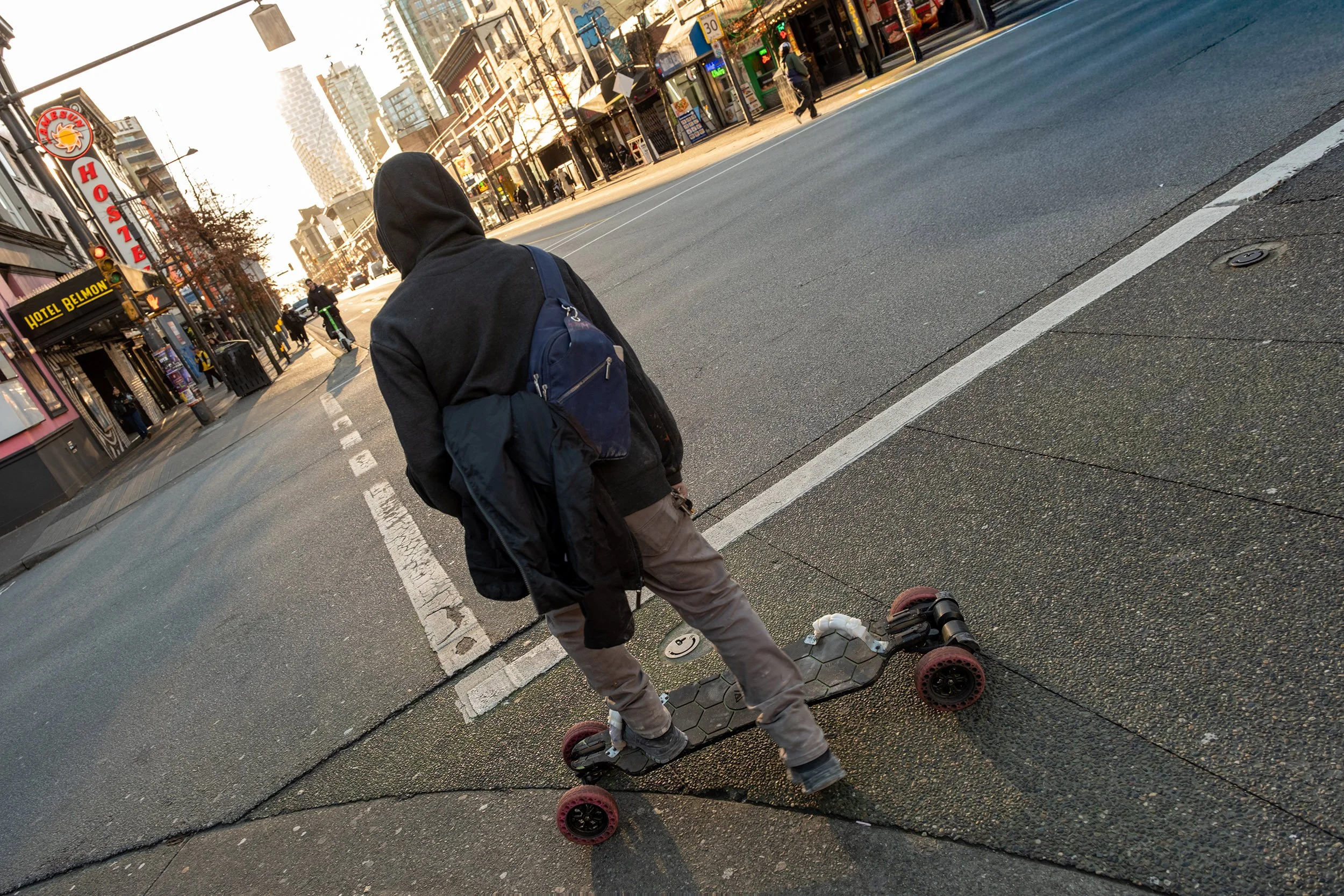 A long boarder on Granville Street in Vancouver. Sample image from a Sigma 17-40mm f/1.8 DC Art and Fujifilm X-E5.
