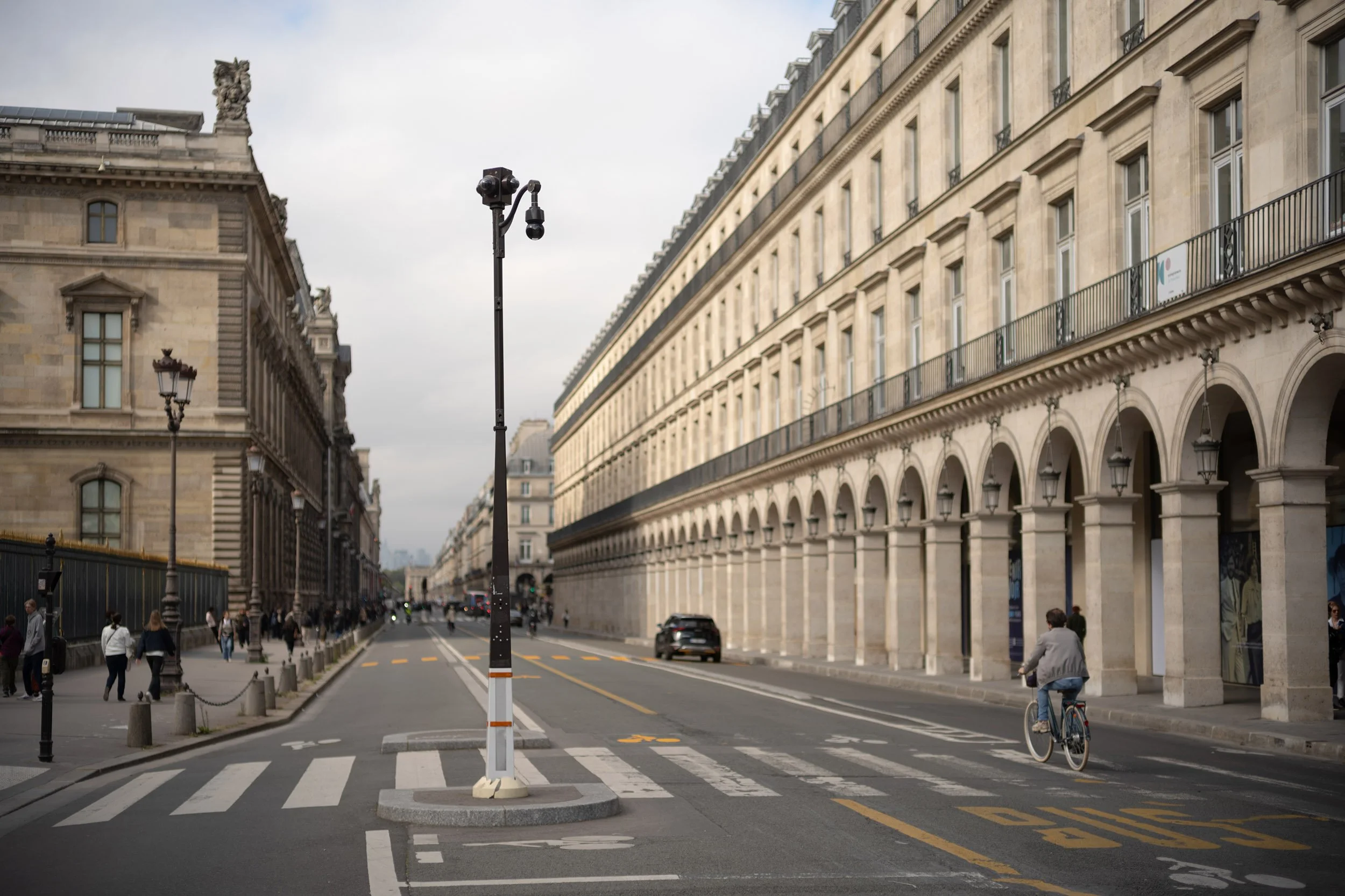 A cyclist on Rue de Rivoli, Paris, France