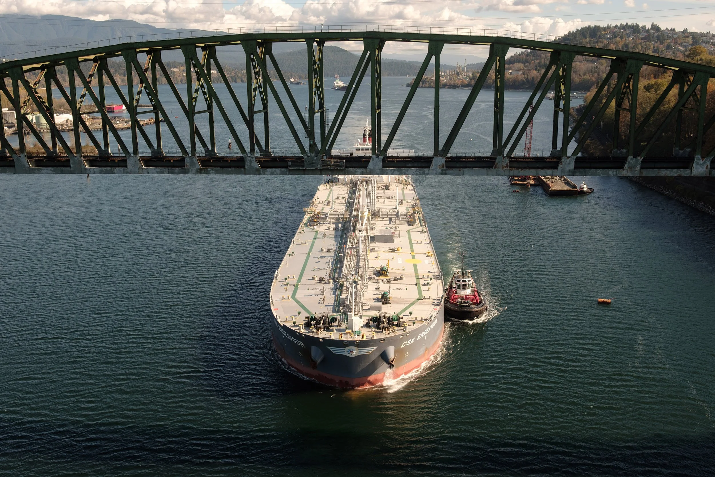Cargo ship and tug boat by Iron Workers Memorial Bridge, October 2026