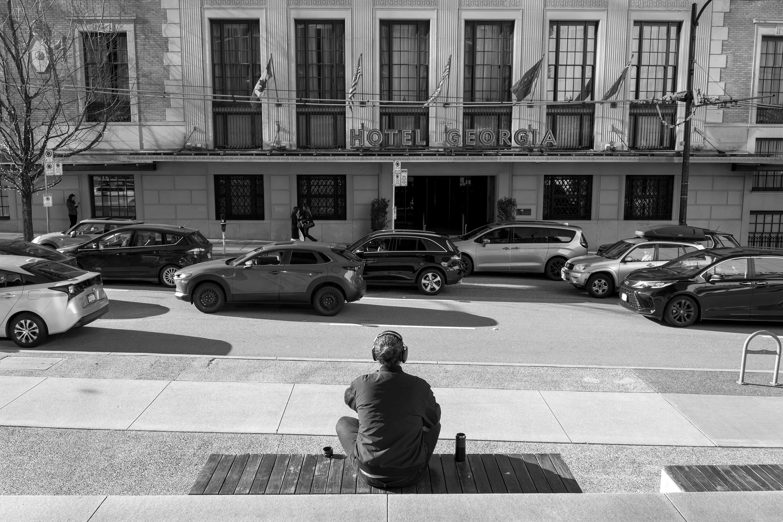 Man listing to music downtown, March 2026