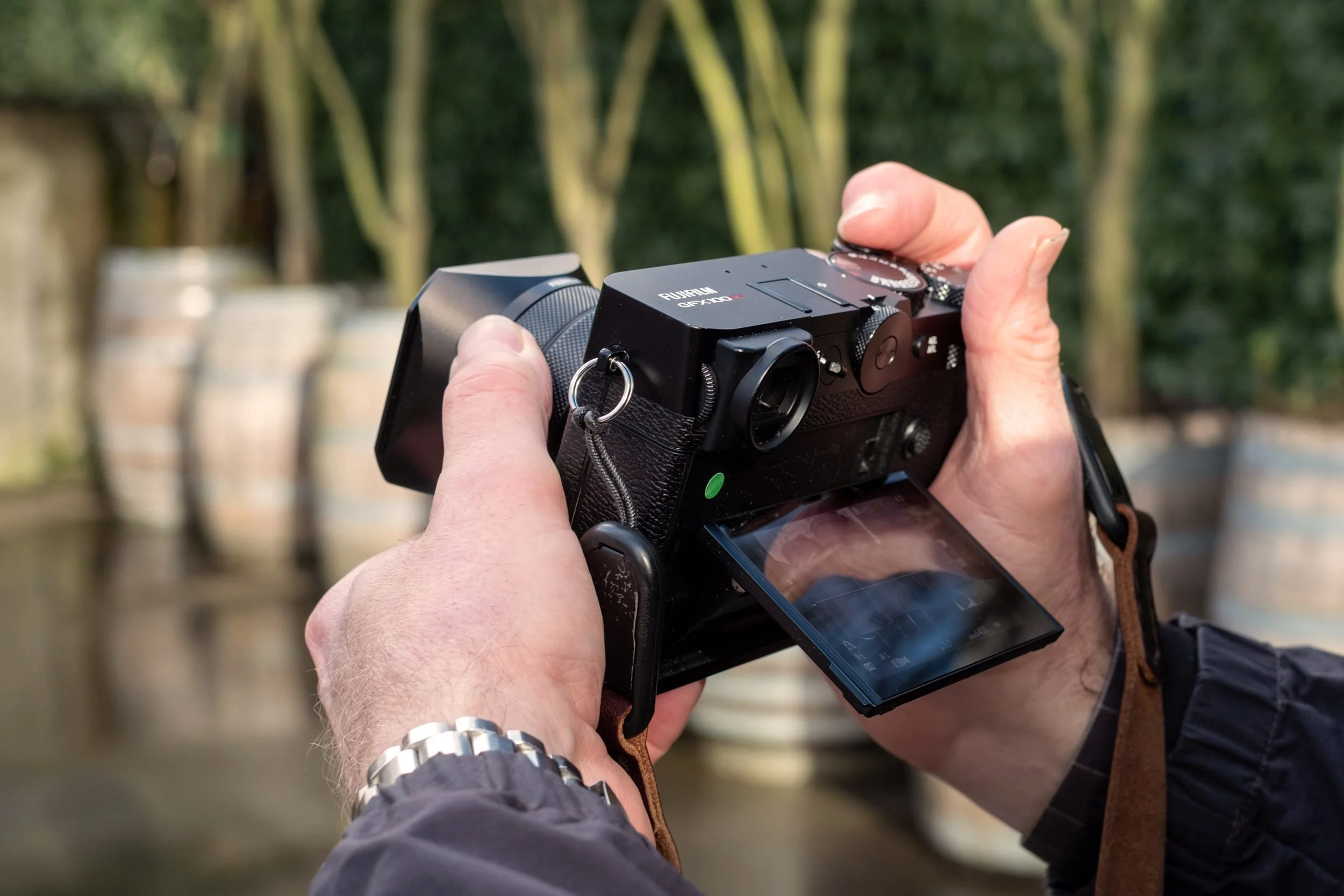 Fujifilm GFX100RF, black, showing the lcd tilted