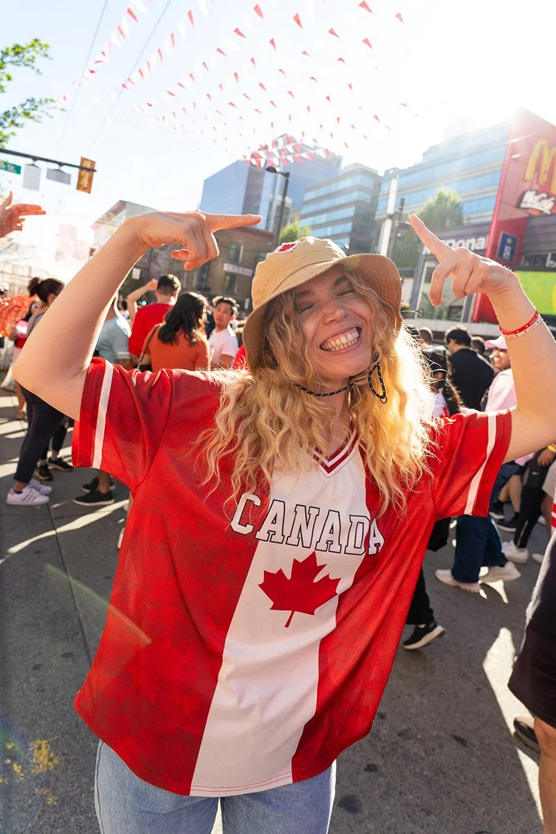 A woman celebrates after Canada wins a game at the 2026 World Cup in Vancouver. Sample image from a Sony FE 20-70mm f/4 G and Sony A7 V.