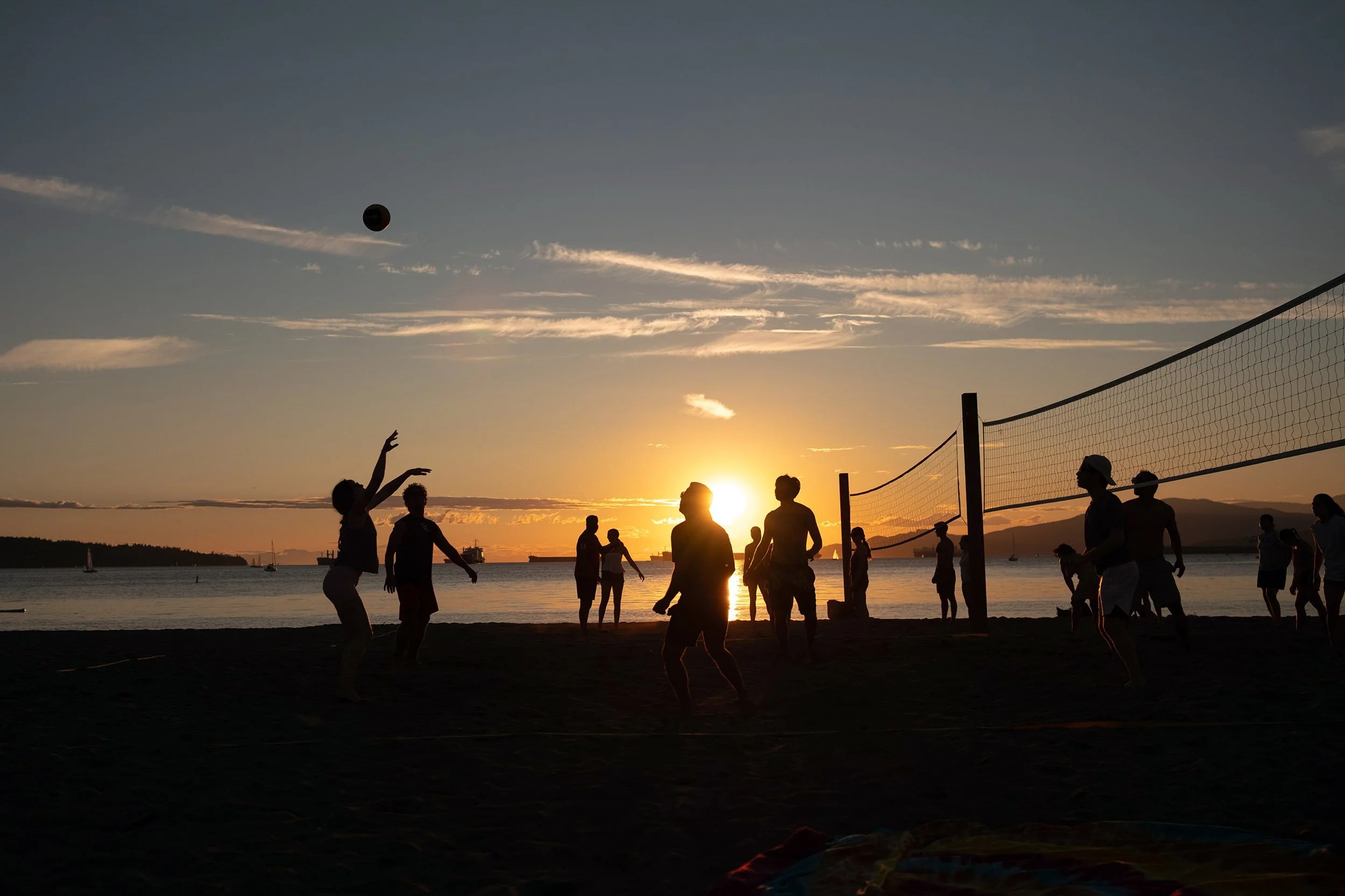 Beach volleyball at English Bay Beach on August 26th, 2026 at sunset.