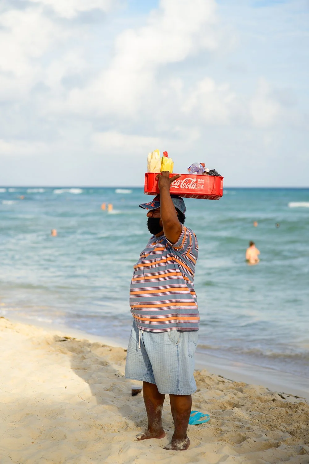 A man is selling drinks and snacks along the beach at the Mayan Riviera. Sample image from a Nikon Zf and Voigtländer Ultron 75mm f/1.9 MC, M-Mount.