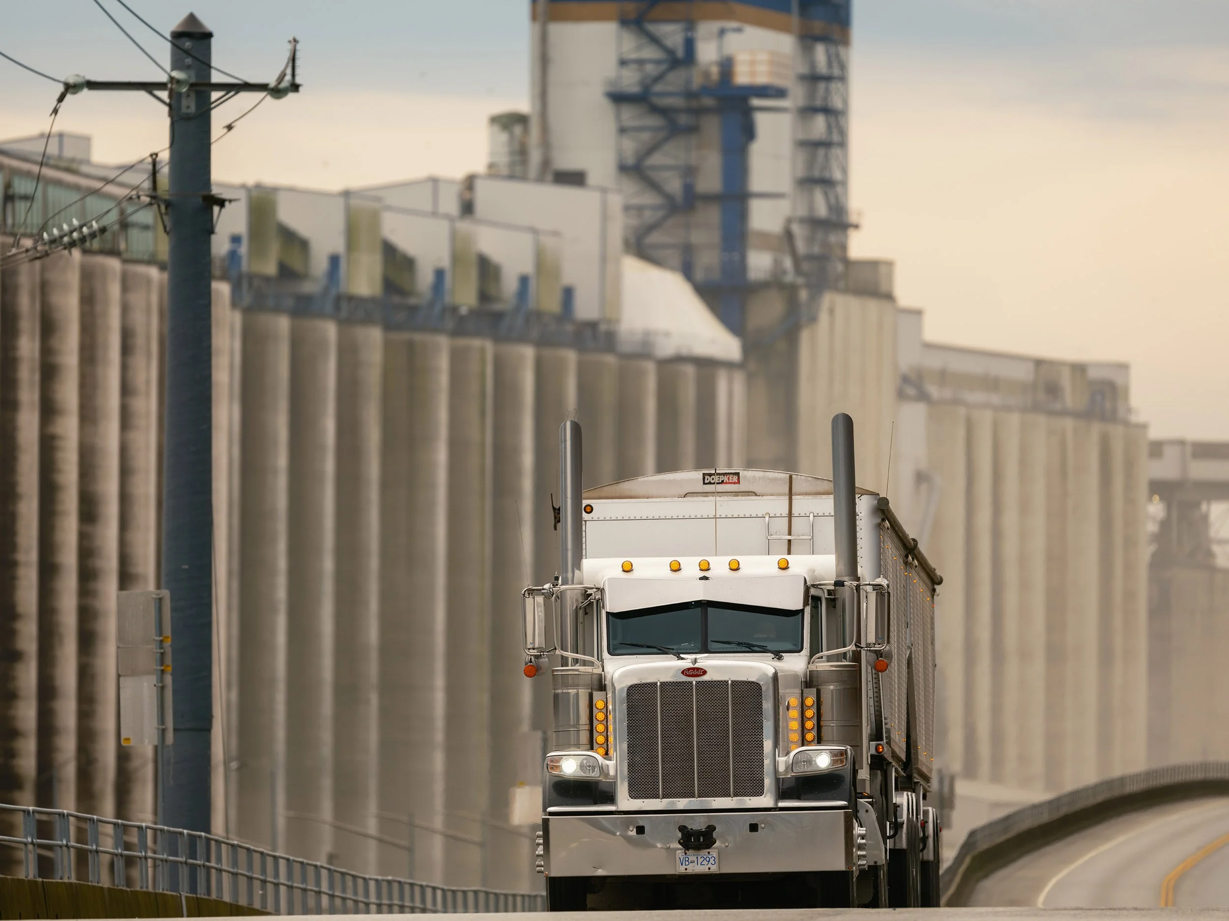 A transport trucks drives by the Cargill Grain Terminal on Low Level Road in North Vancouver. Sample image from a Fujifilm GF 500mm f/5.6 R LM OIS WR and Fujifilm GFX 100S II.