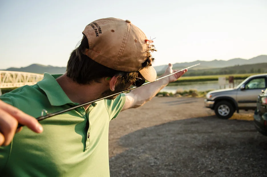  Nick Erler checks the guides on his rod while preparing to fish the Missouri near Craig, Mont., on a beautiful July evening. Missouri River, 2013 