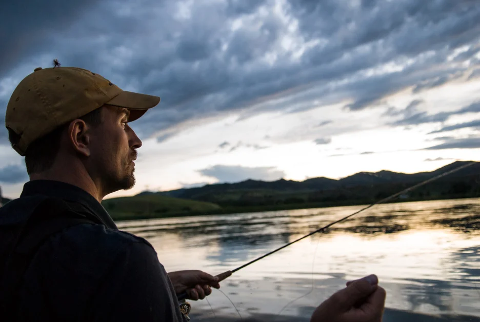  Kurt Ross observes the water after a cast as the sun sets on the Missouri River. Missouri River, 2008 