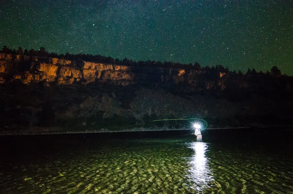  Beneath flickering starlight, angler Nick Erler casts for brown trout beneath Hauser Dam on the Missouri River near Helena, Mont. The orange glow on the canyon rocks is the result of the dam's light shining from about a half-mile upstream. Missouri 