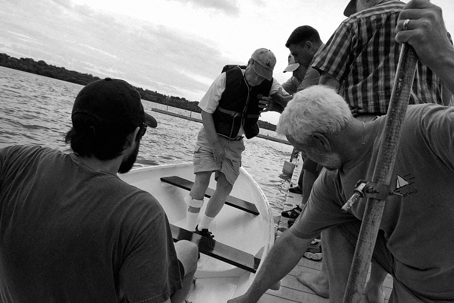 Friends help my dad into his boat on Lake Harriet in Minneapolis on August 12, 2010.