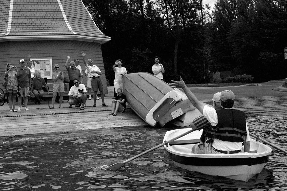 My dad waves to friends and family on shore who came to see him launch the boat he built into Lake Harriet in Minneapolis on August 12, 2010.