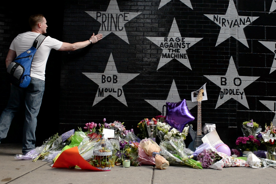 A fan pays his respects to Prince at an impromptu memorial for the musician that was set up at First Avenue in Minneapolis, Minn., by mourners the day the musician died, Thursday, April 21, 2016 (visit my multimedia page to see a video I did co