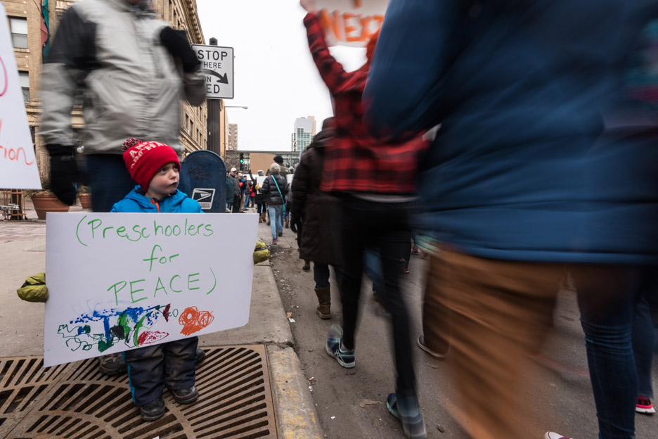 Nicodemous Johnson, 4, watches as protestors go by during the March For Our Lives anti-gun violence protest in St. Paul, Minn., Saturday, March 24, 2018. His mom, Elle, says she’s scared but hopeful for his future.