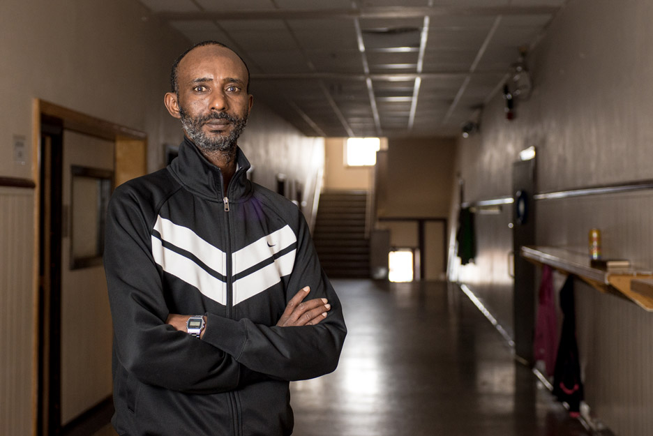 Mohamednour Aded, 38, poses for a photo in the hallway of former Garfield Elementary School, which is now a mosque that was started by the Islamic Center of St. Cloud in St. Cloud, Minn. Aded came to the United States in 2013 and was injured while w