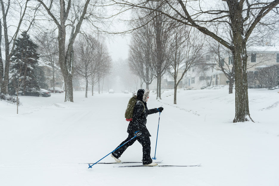 Ellen Block crosses the intersection of West 48th Street and Aldrich Avenue South in Minneapolis, Minn., while cross-country skiing during a blizzard, Saturday, April 14, 2018. Block was bringing her son Sam McGrath, 8, (not pictured) to a birthday