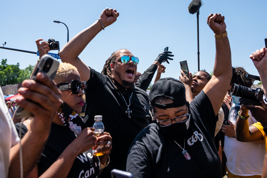 Rev. Greg Drumwright, of Greensboro, N.C., center, celebrates with the crowd outside Cup Foods in Minneapolis, Minn., after the announcement of all four officers being charged in the death of George Floyd on Wednesday, June 3, 2020. “Minneapolis is