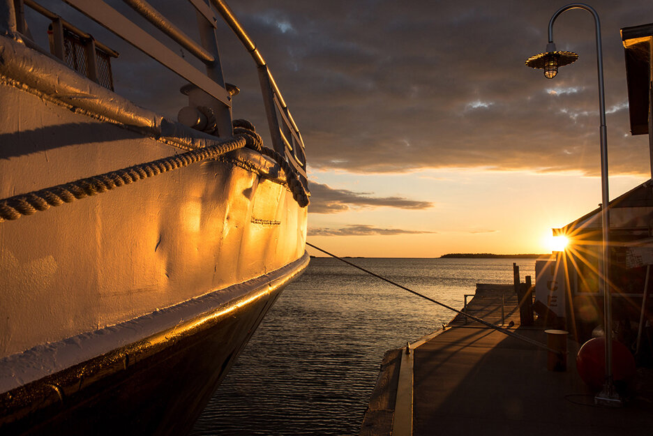 The sun rises over Copper Harbor, Mich., on Lake Superior before the Isle Royale Queen IV departs to take passengers to Isle Royale National Park, Monday, Sept. 21, 2015.