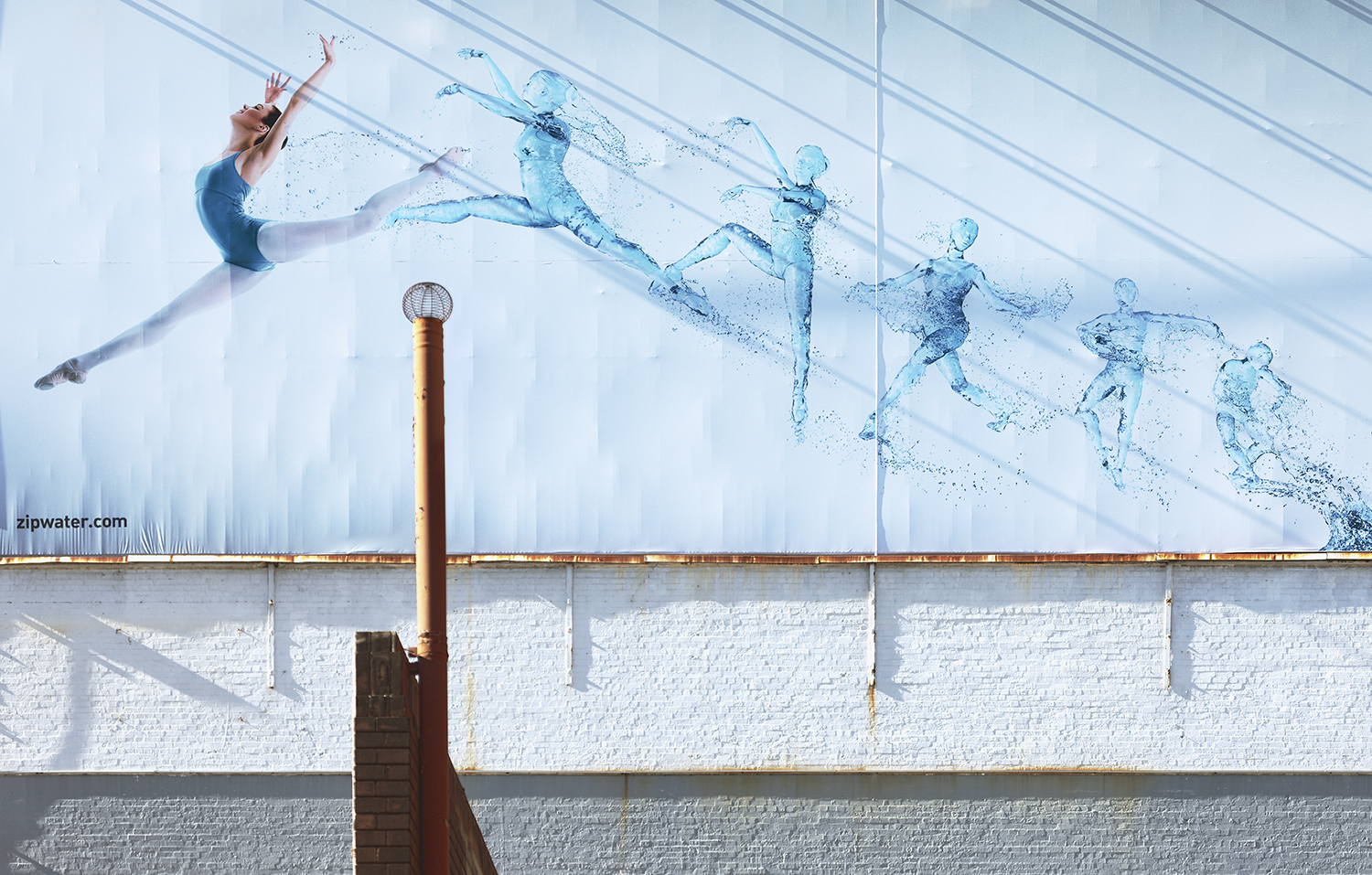 Zip Water Ballerina billboard perfectly captured on the street by photographer Marion Abada. See more of her work here .