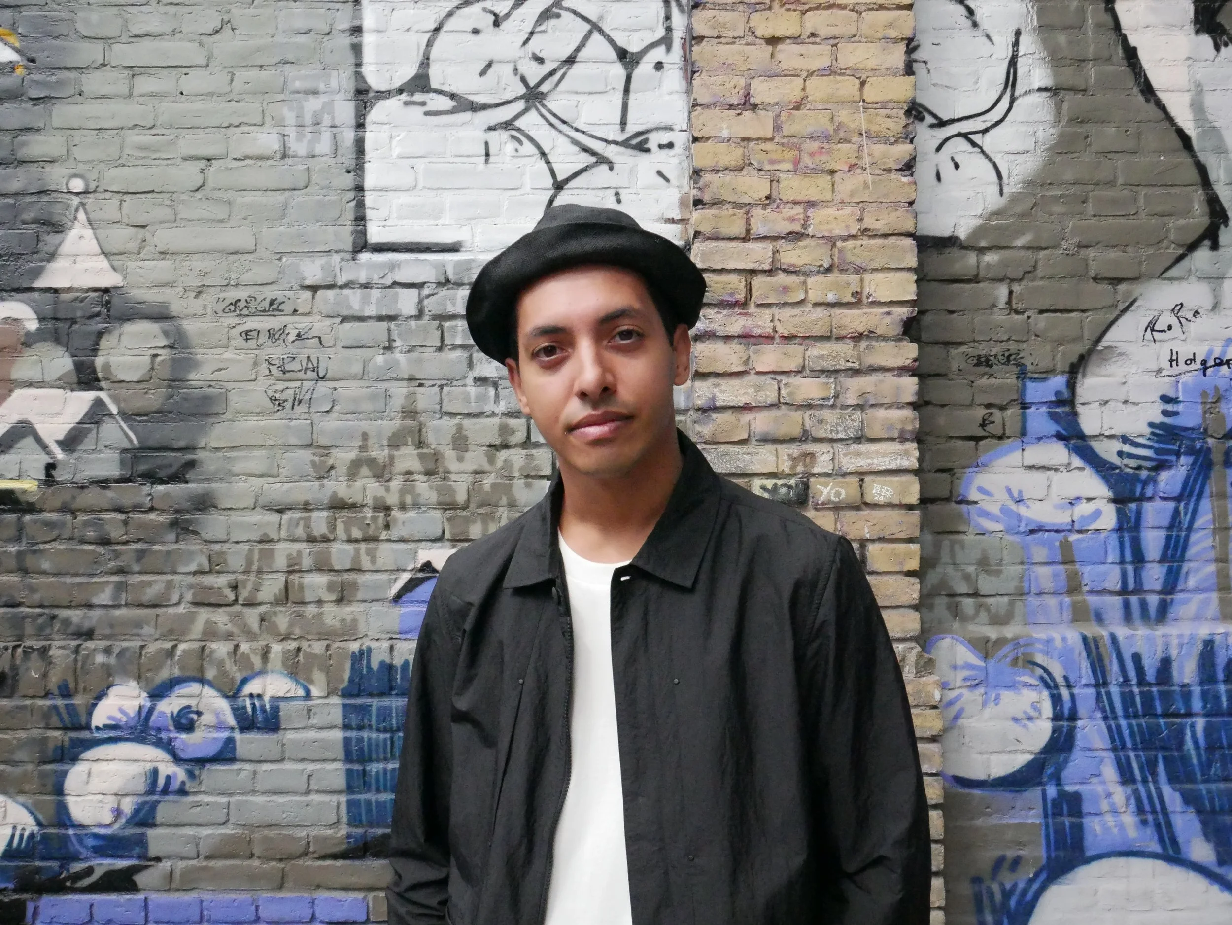 Maikol Piardi with a cool hat with graffiti background