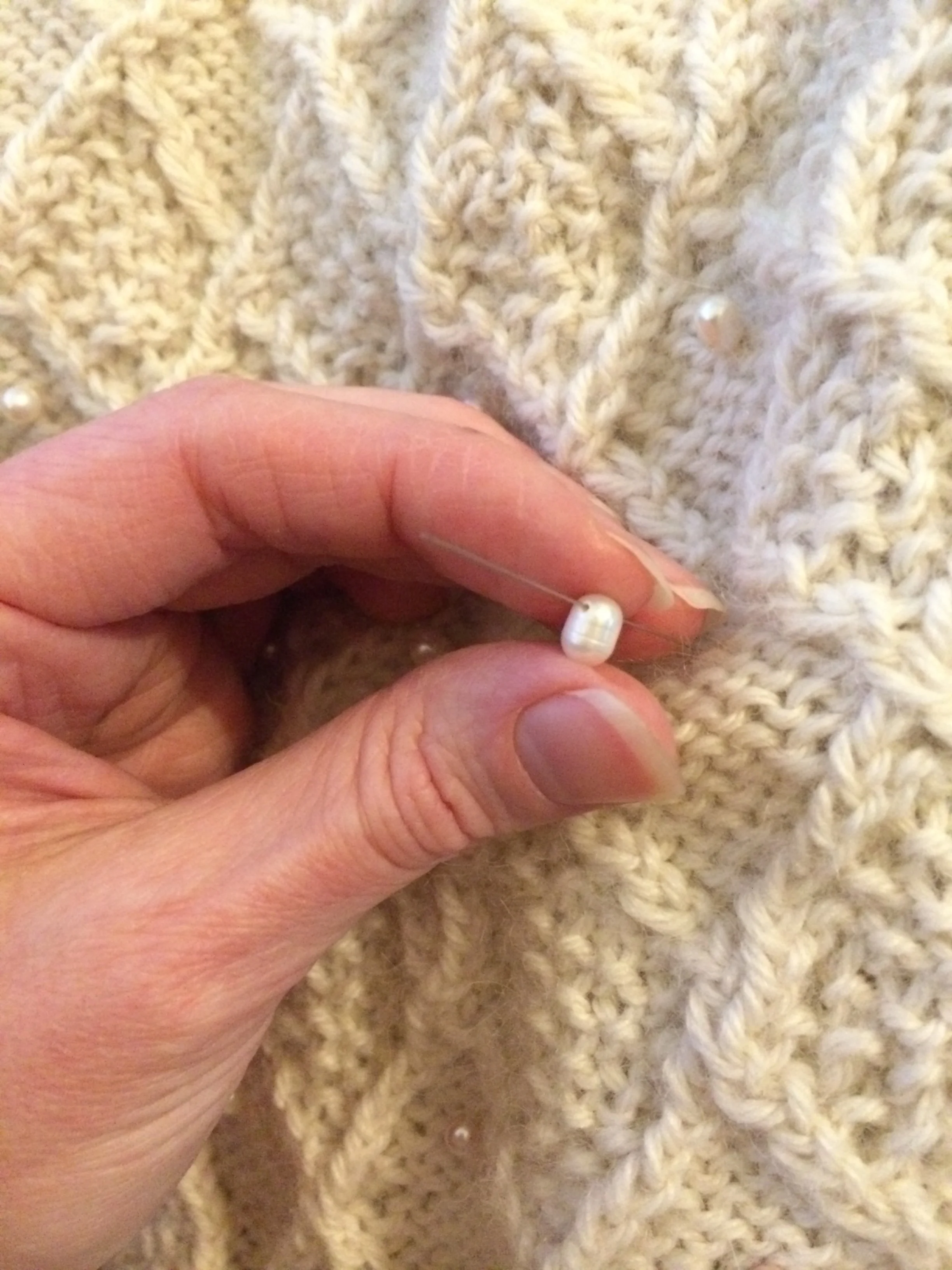 Sewing on the pearls.