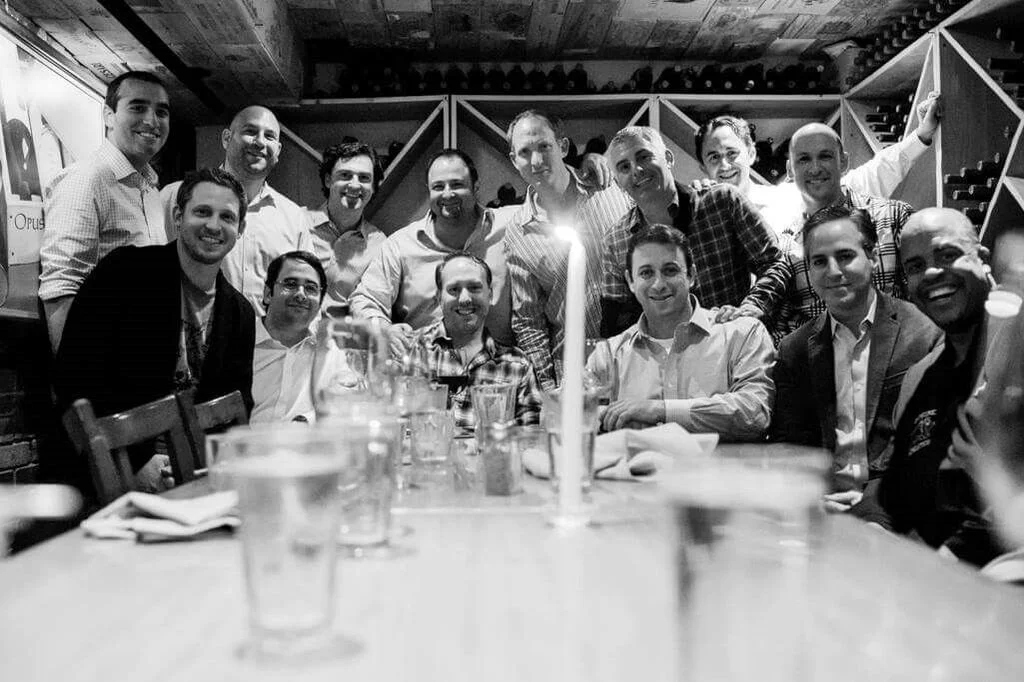 1970s-2000s—November in NYC: Seated— Cory Schwartz, Josh Friedman, Lawrence Thaler, Eric Strauss, Josh Camhi, Ging Vann ; Standing— Josh Koretsky, Aaron Wattenberg, Jon Tucker, Eric Kleiner, Greg Mazarin, Todd Fass, Michael Vickers , and Doug Florin. 