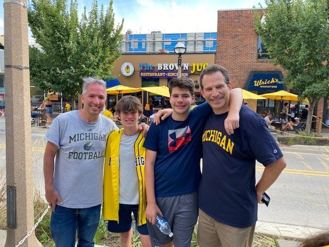 Two Scatico generations at a University of Michigan football game:  1970s-80s dads Roger Lowenthal and Jeff Hellman with sons (and current campers and bunkmates) Noah and Spencer.