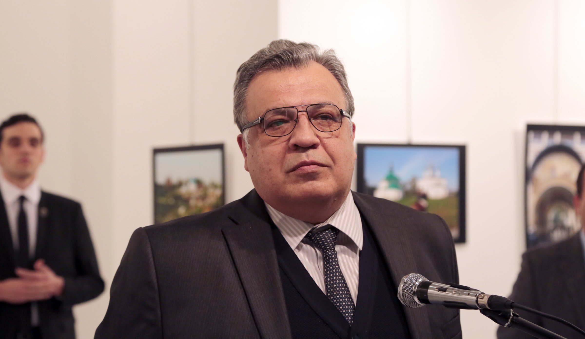 Photo of Karlov taken moments before he was assassinated. Karlov's assassin is seen in the background on the left. Credit: Burhan Ozbilici/AP