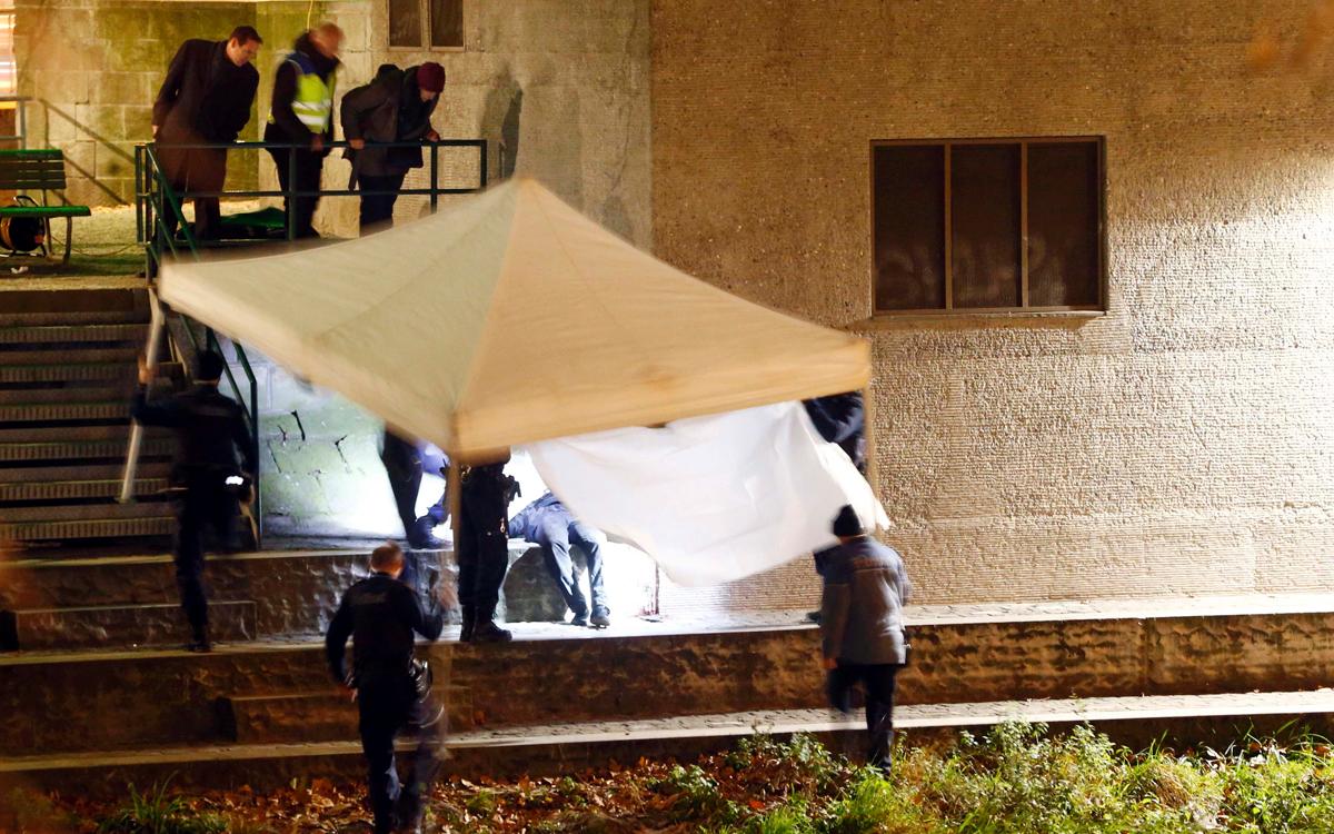 Body of suspect found near the mosque, is covered by police. Credit ARND WIEGMANN/REUTERS